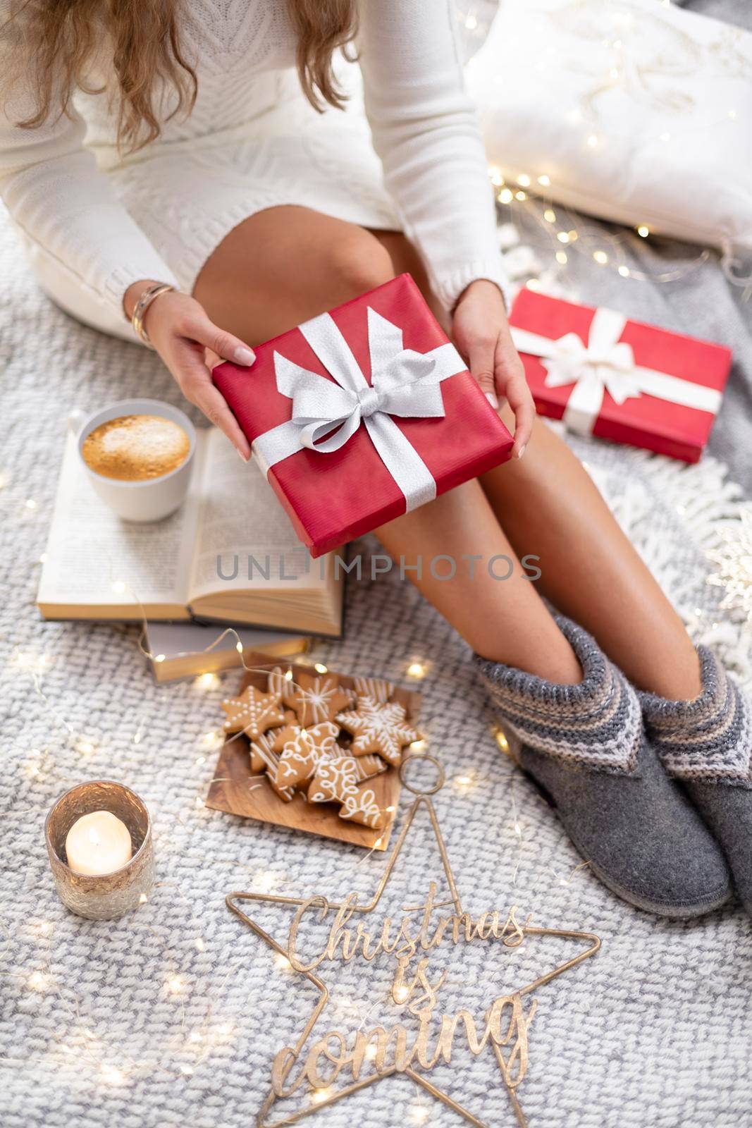 Woman legs with christmas socks and gifts.