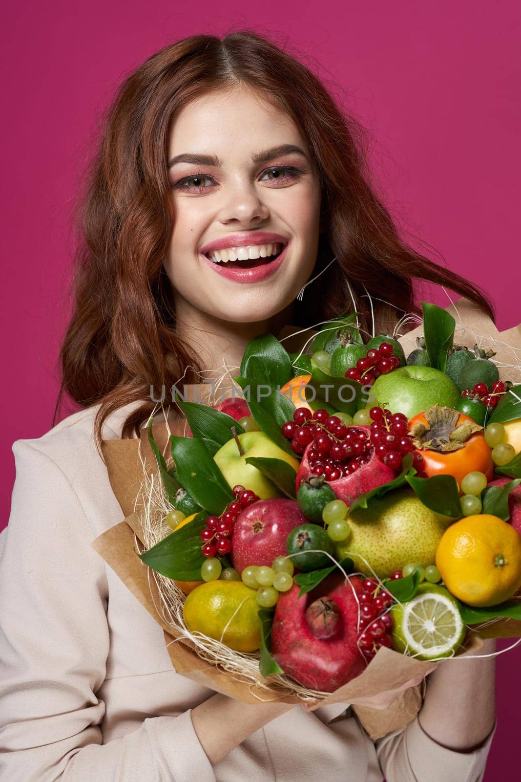 portrait of a woman bright makeup attractive look a bouquet of fruits Studio Model. High quality photo