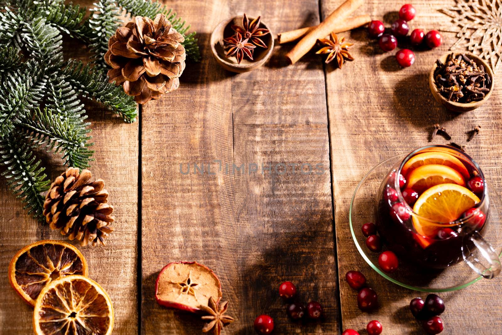 Christmas mulled wine with spices on a wooden rustic table.