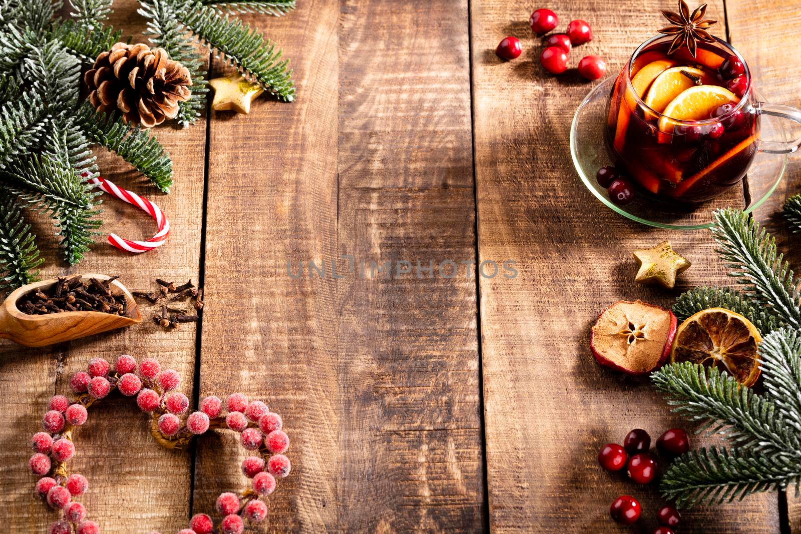 Christmas mulled wine with spices on a wooden rustic table.