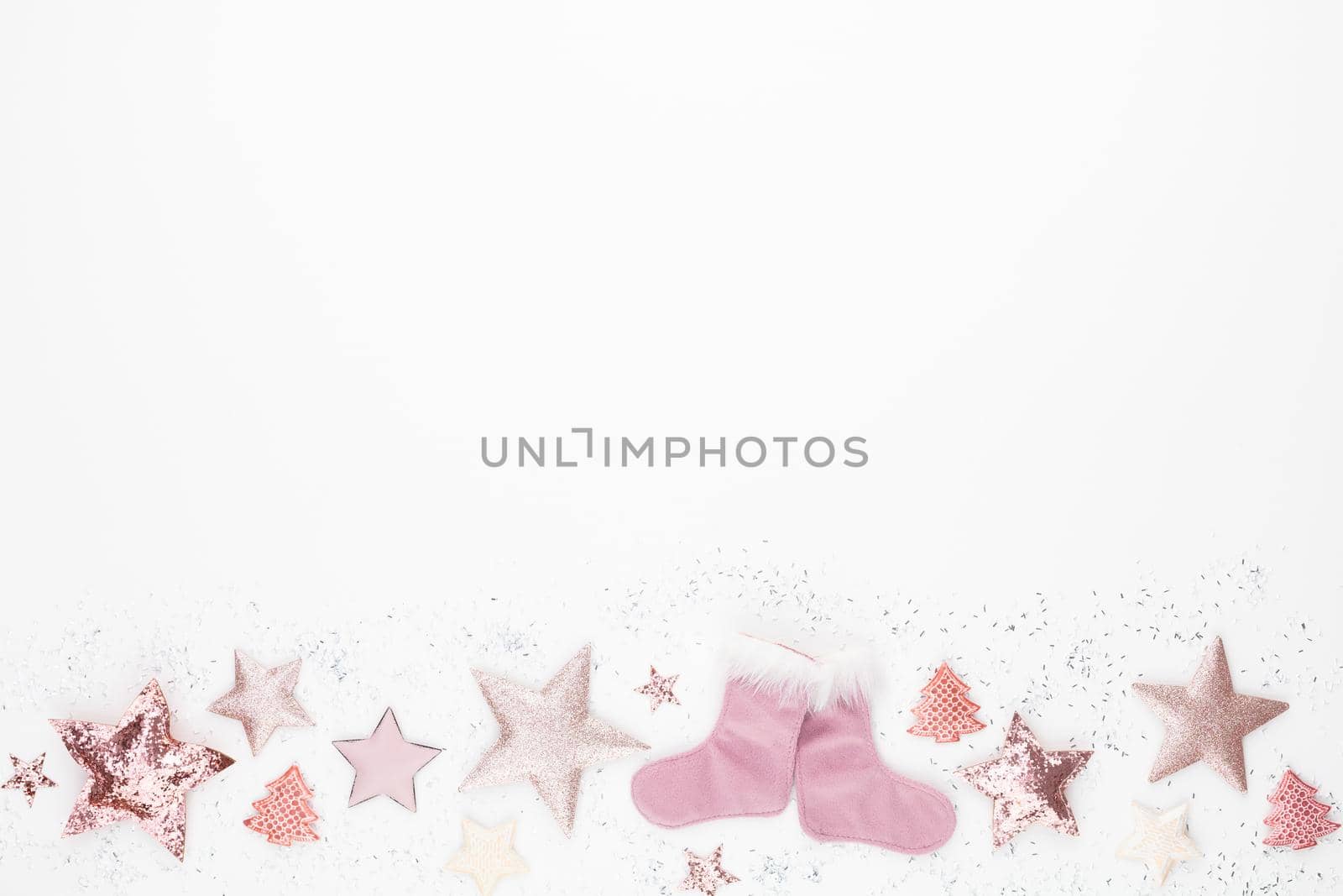 Christmas minimalistic and simple composition in pink color. Christmas star, decorations on white background. Flat lay, top view with copy space