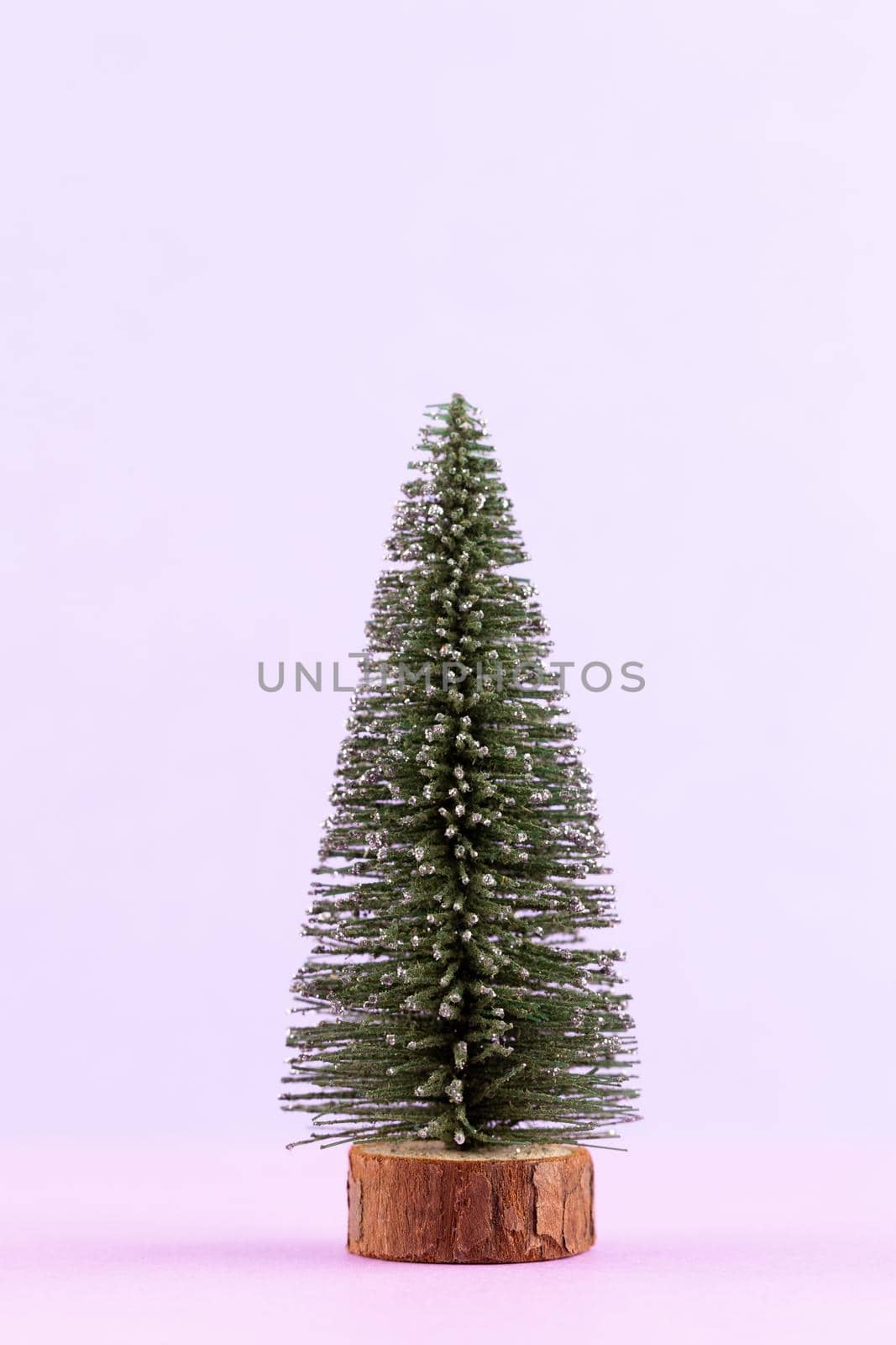 Christmas tree on pastel colored background. Christmas or New Year minimal concept. by gitusik