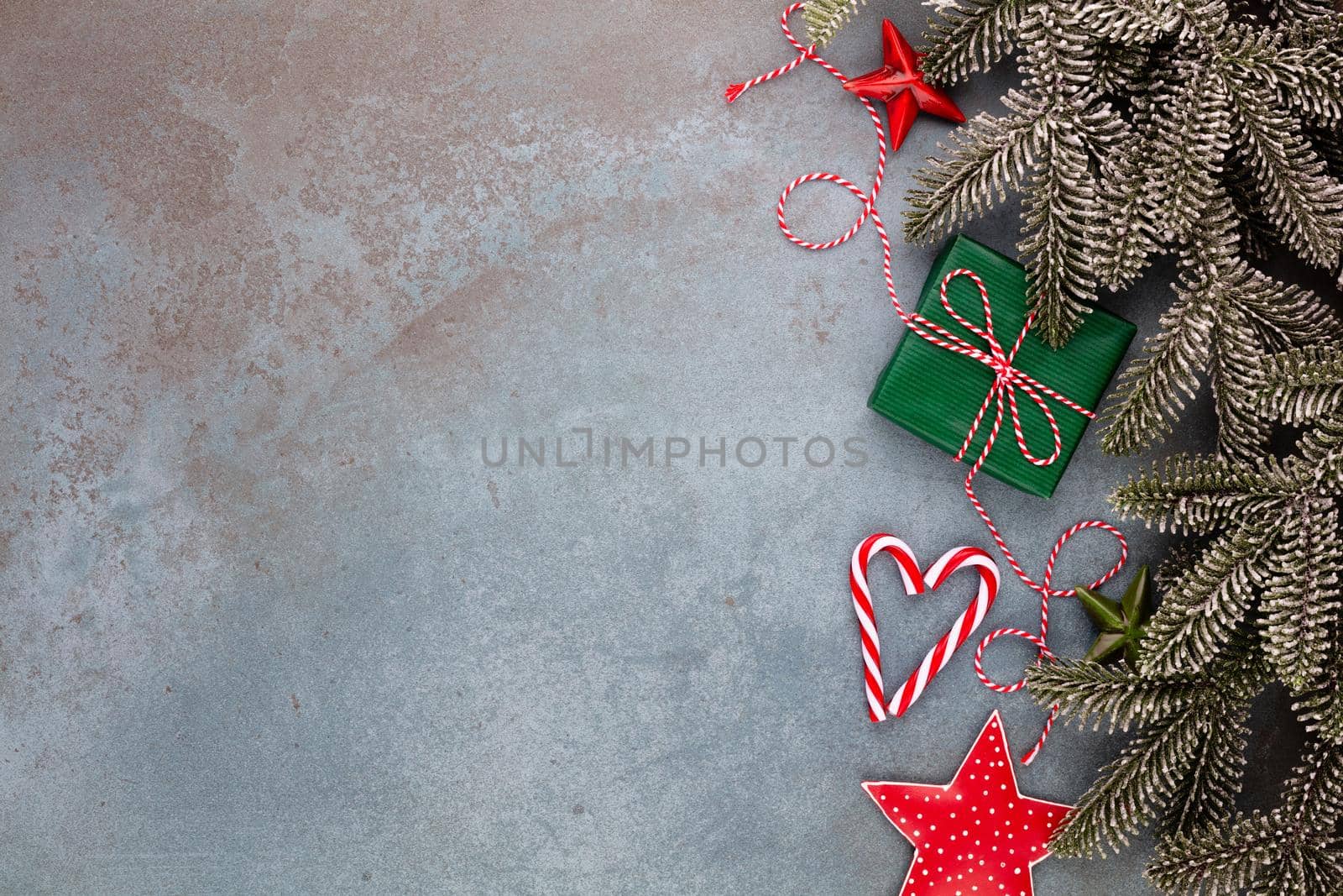 Christmas composition fir tree branches, star decor on blue background.