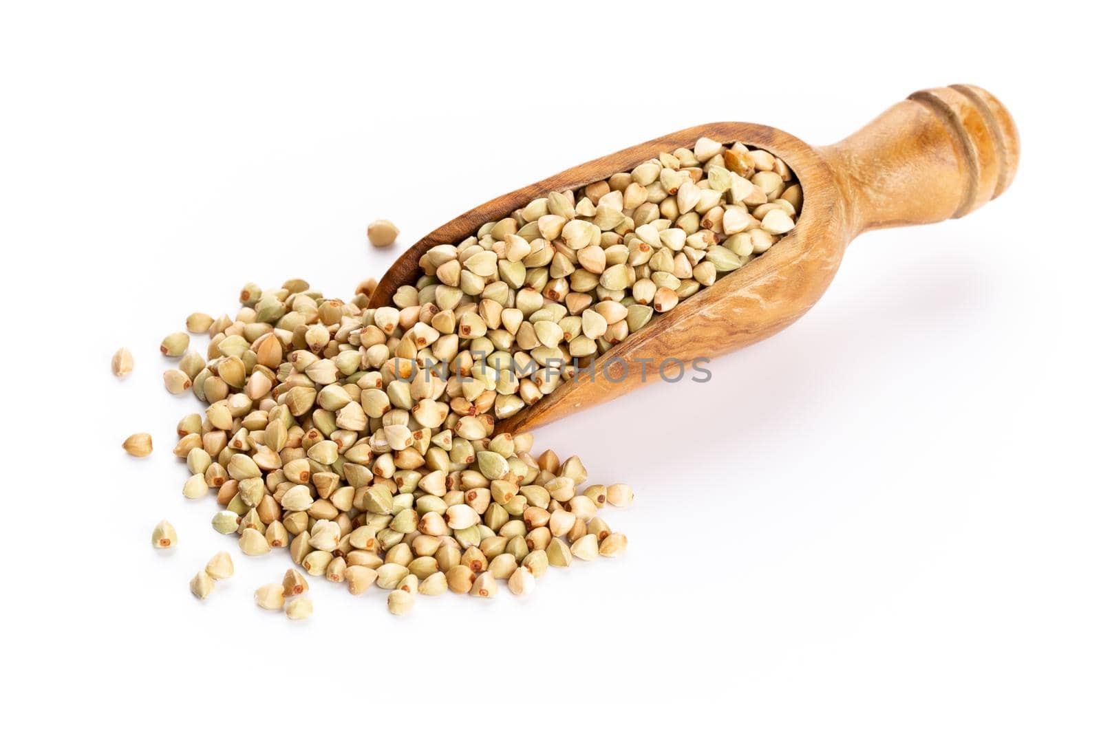 Raw buckwheat and wooden spoon on white background.