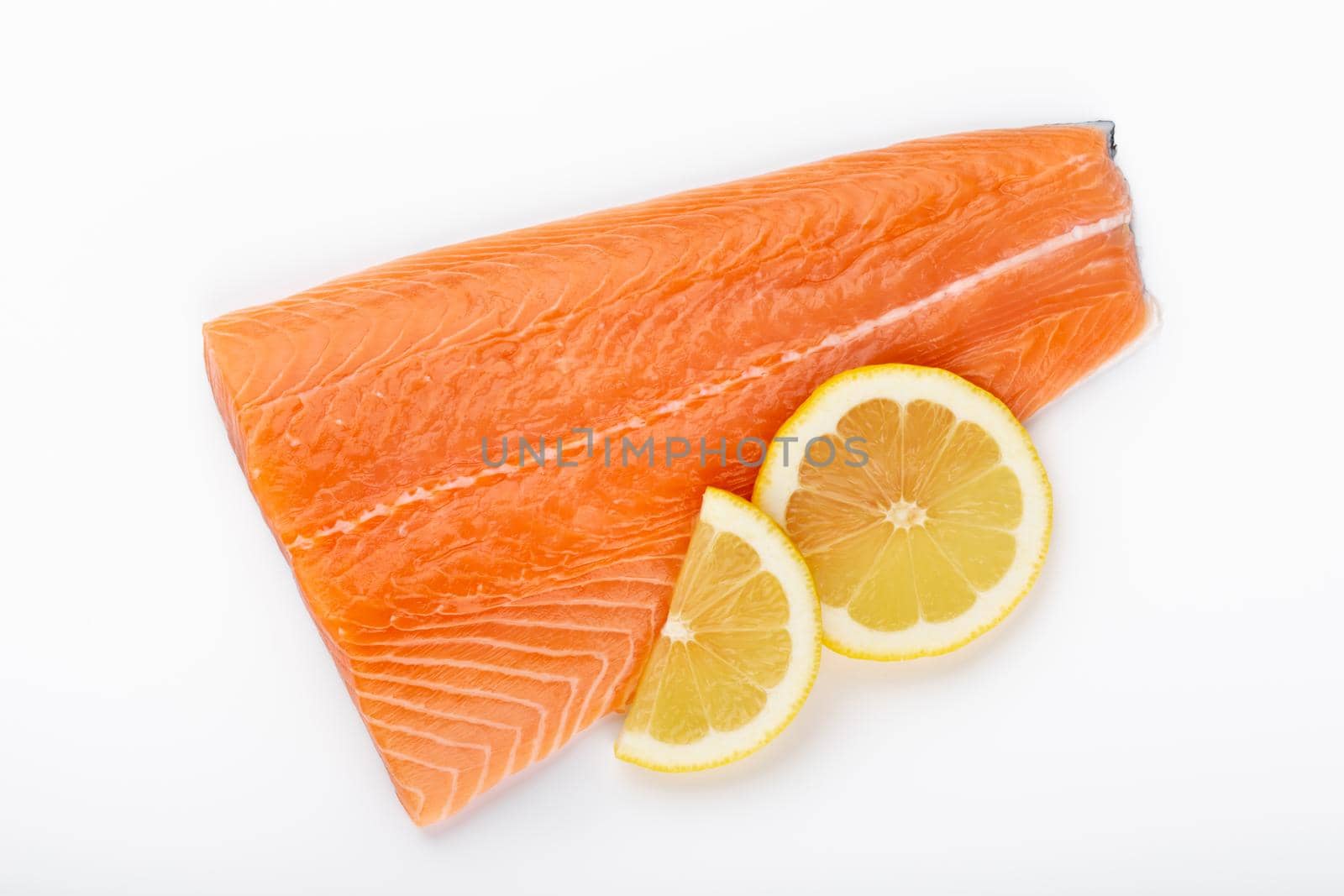 Slice of red fish salmon with lemon, basil isolated on white background. Top view. Flat lay