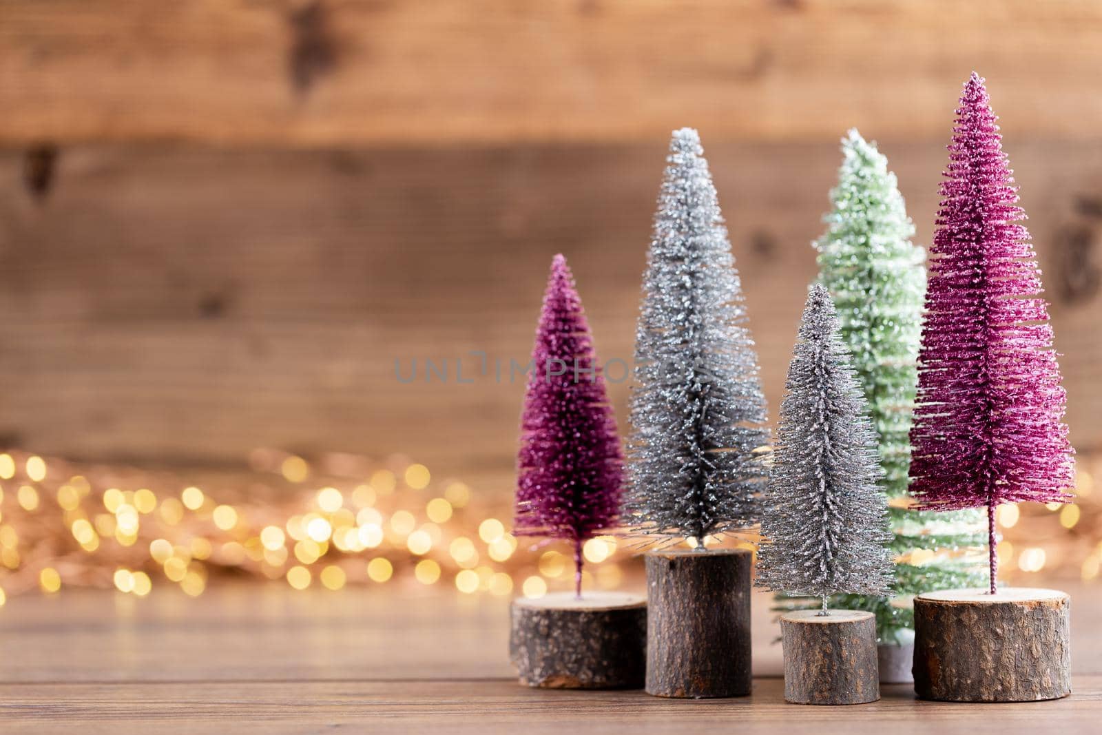Colorful Christmas tree on wooden, bokeh background. Christmas holiday celebration concept. Greeting card.