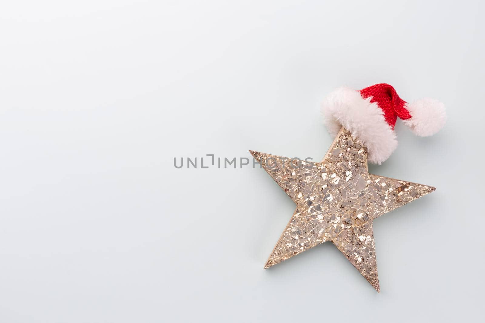 Christmas star and santa hat, decor on pastel blue background. 