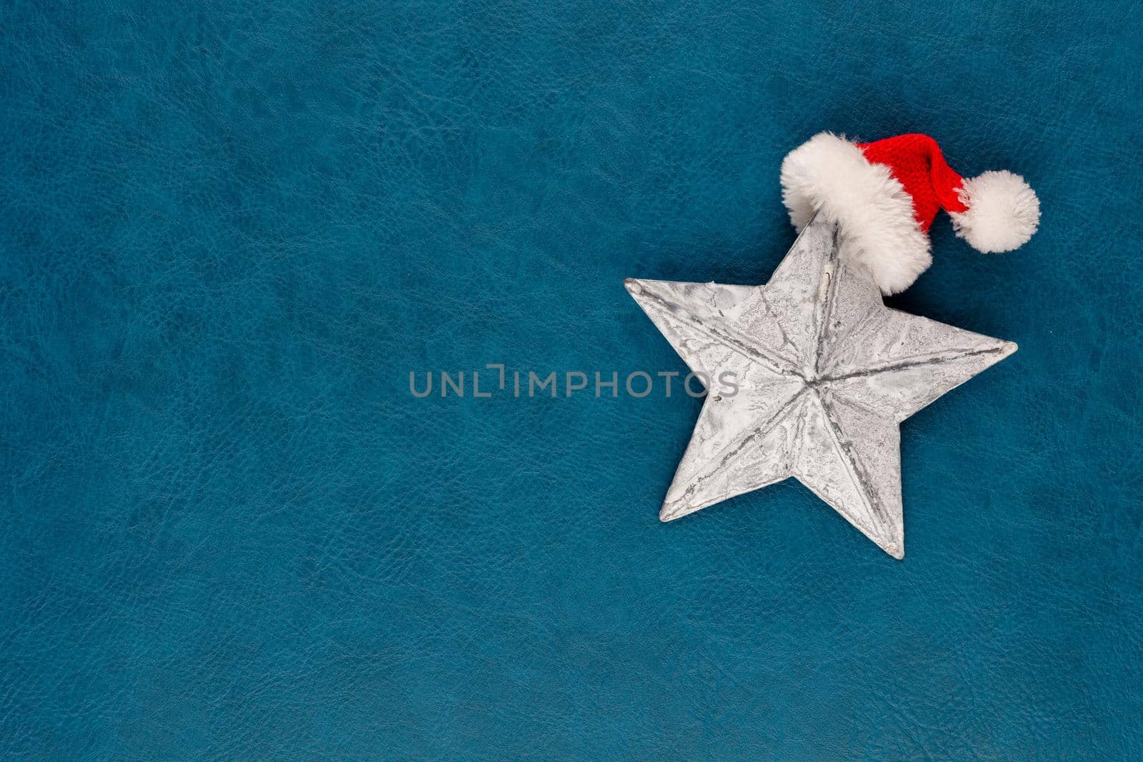 Christmas star with santa hat decoration. Christmas star on blue background.