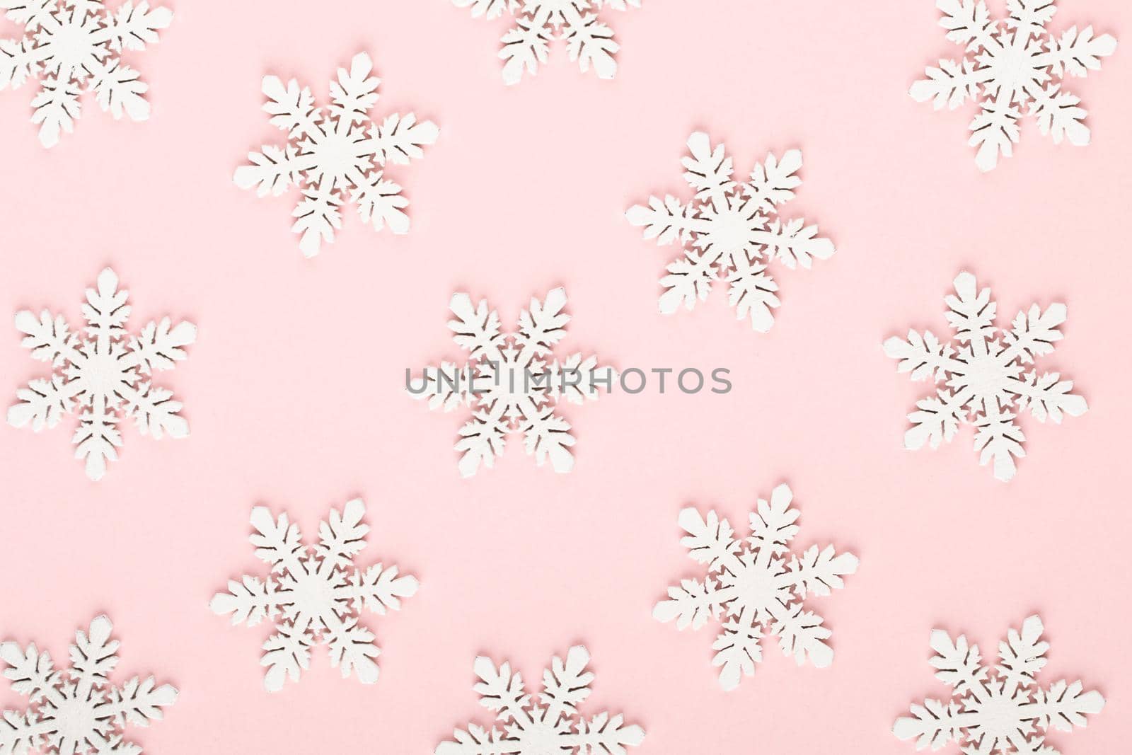 Christmas background. White snow decorations on a pink background. by gitusik