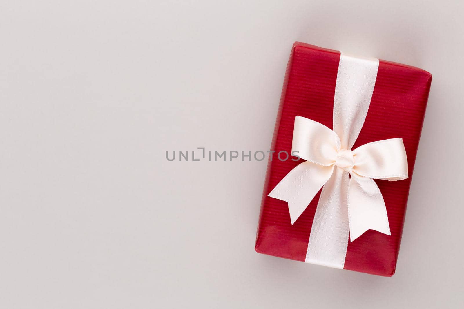 Christmas gift boxes with ribbons on color tabletop. by gitusik