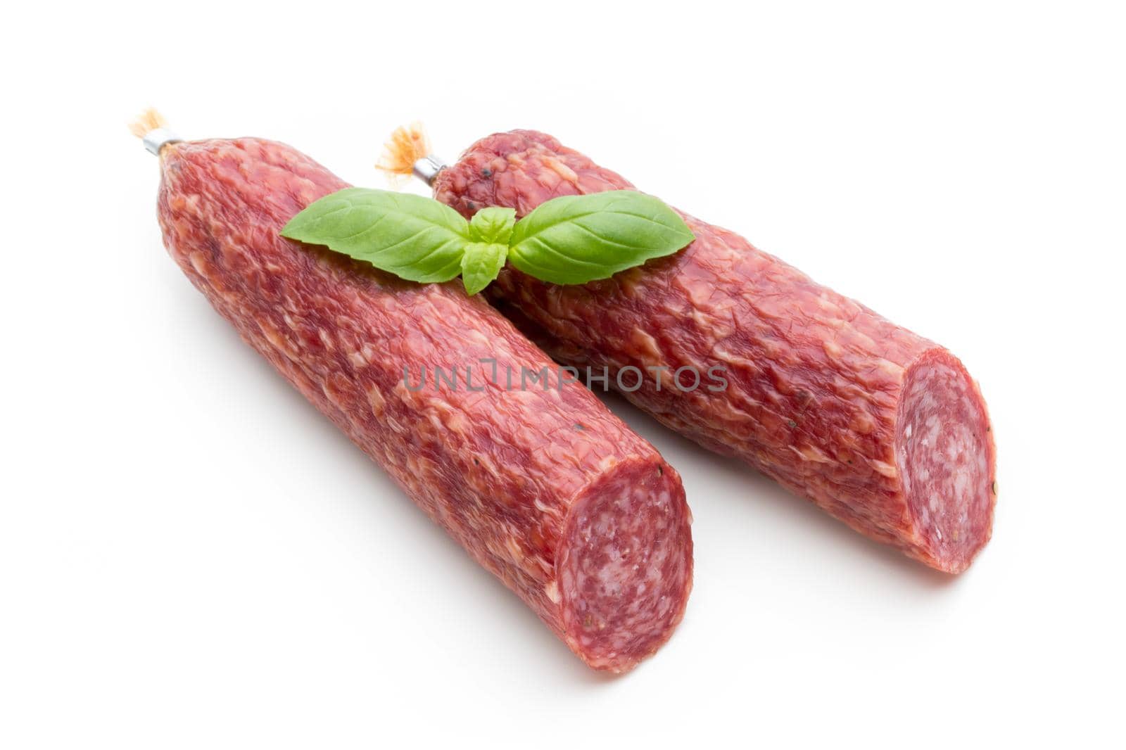 Salami smoked sausage, basil leaves and peppercorns isolated on white background. by gitusik