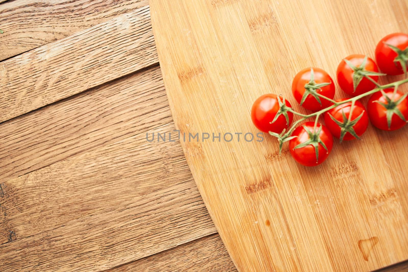 cherry tomatoes on a branch fresh food ingredients for salad by Vichizh