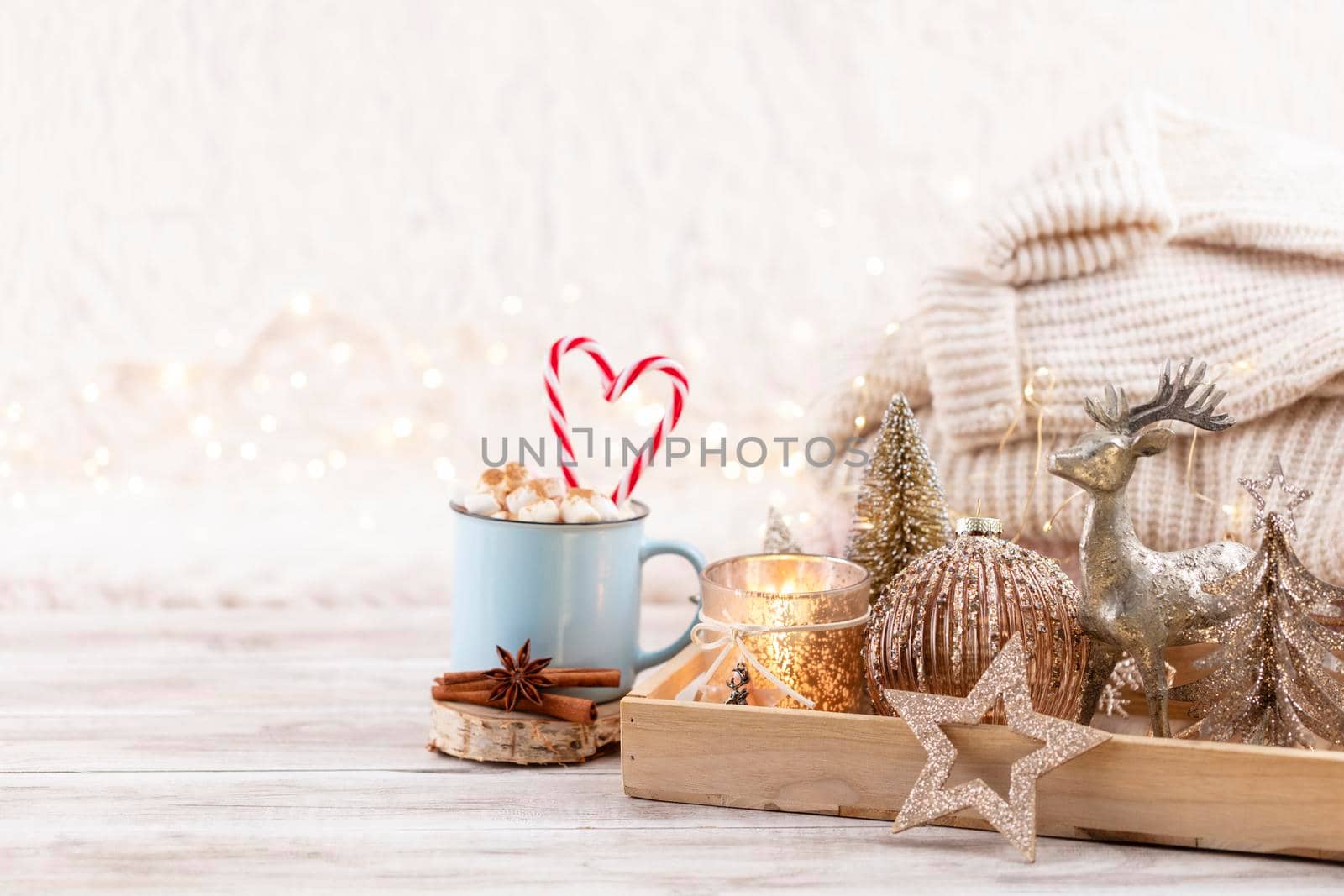Cup with a hot drink, marshmallow on a table with christmas decorations. by gitusik
