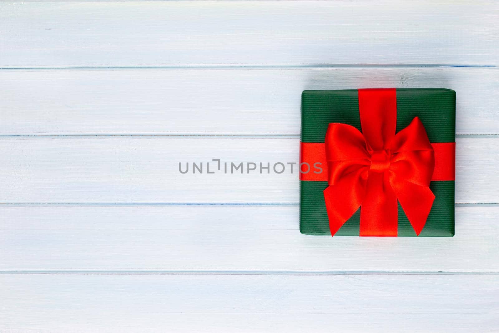 Christmas, holiday present box on red background. by gitusik