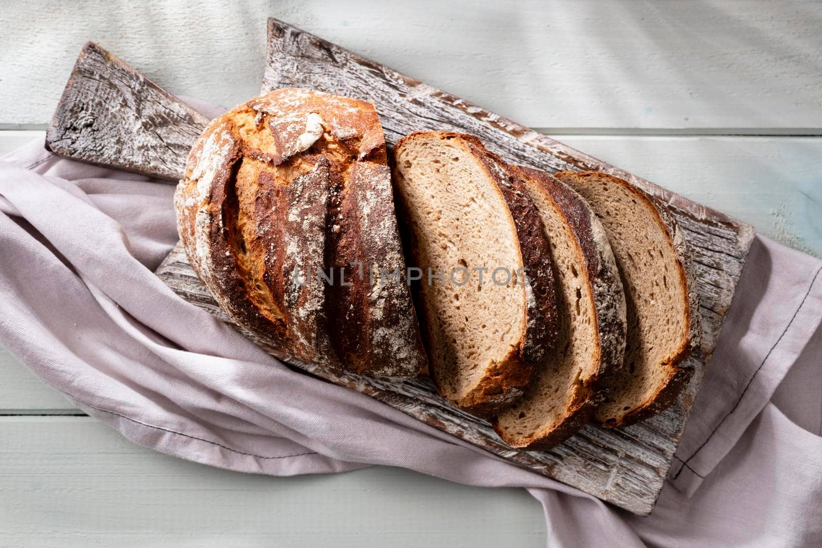 Sliced rye bread on cutting board, closeup. by gitusik
