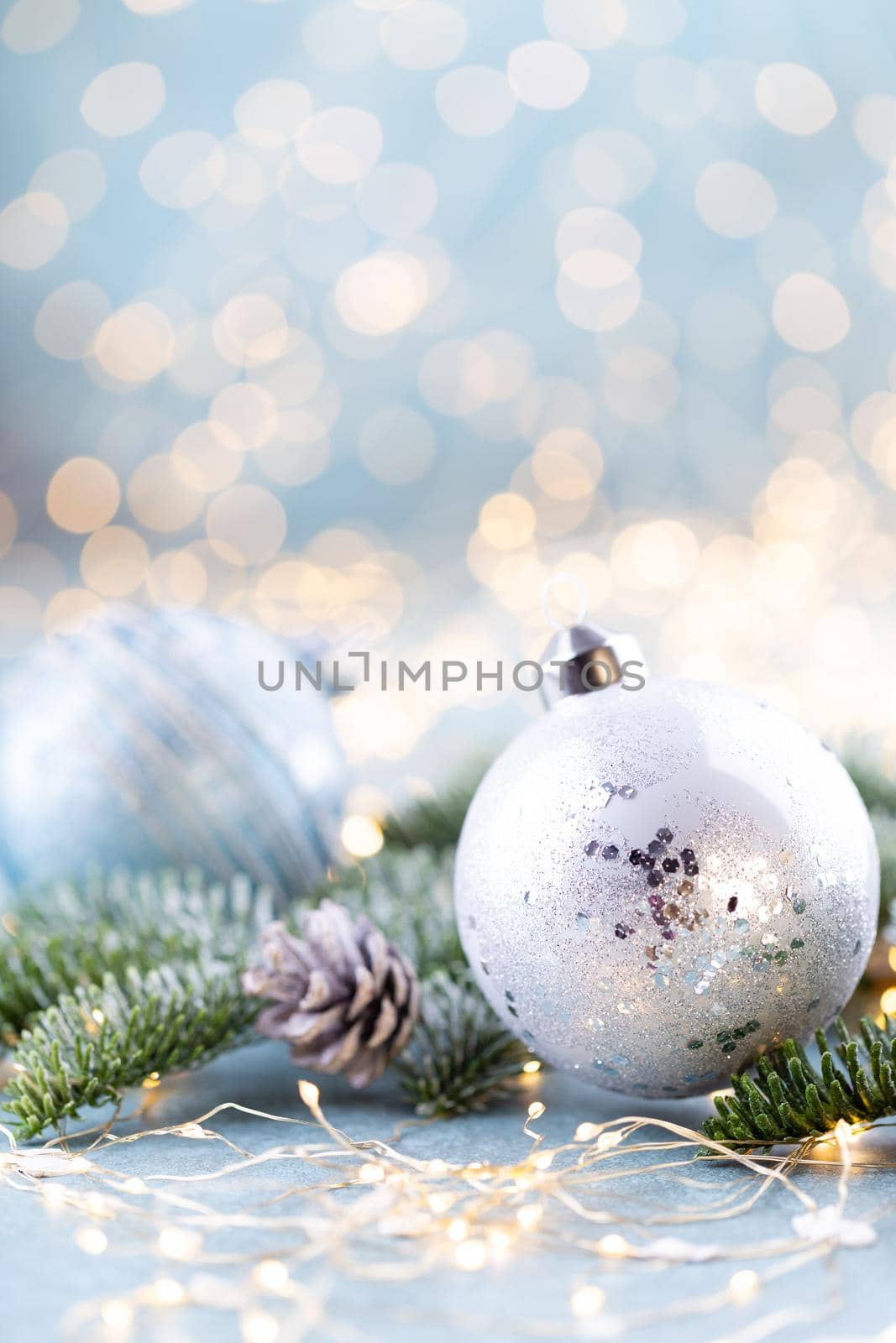 Christmas spruce with ball and blurred shiny lights. by gitusik