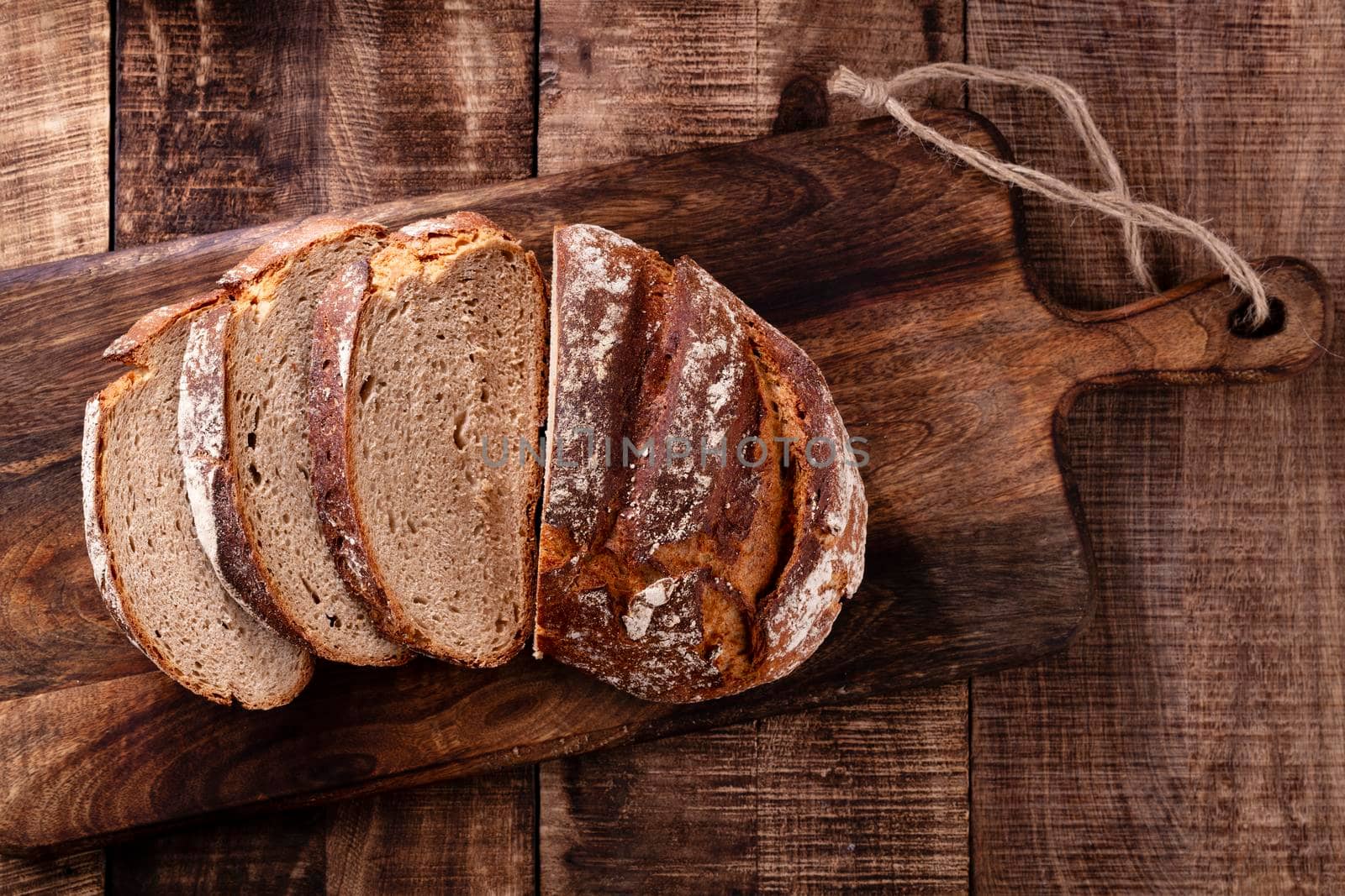 Sliced rye bread on cutting board, closeup.. by gitusik