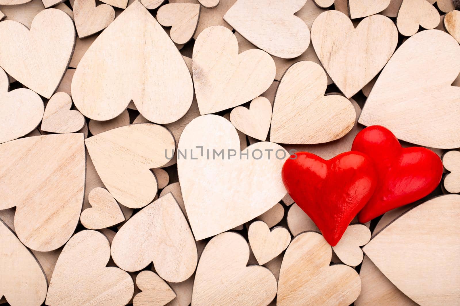 Wooden hearts, one red heart on the wooden heart background.	




