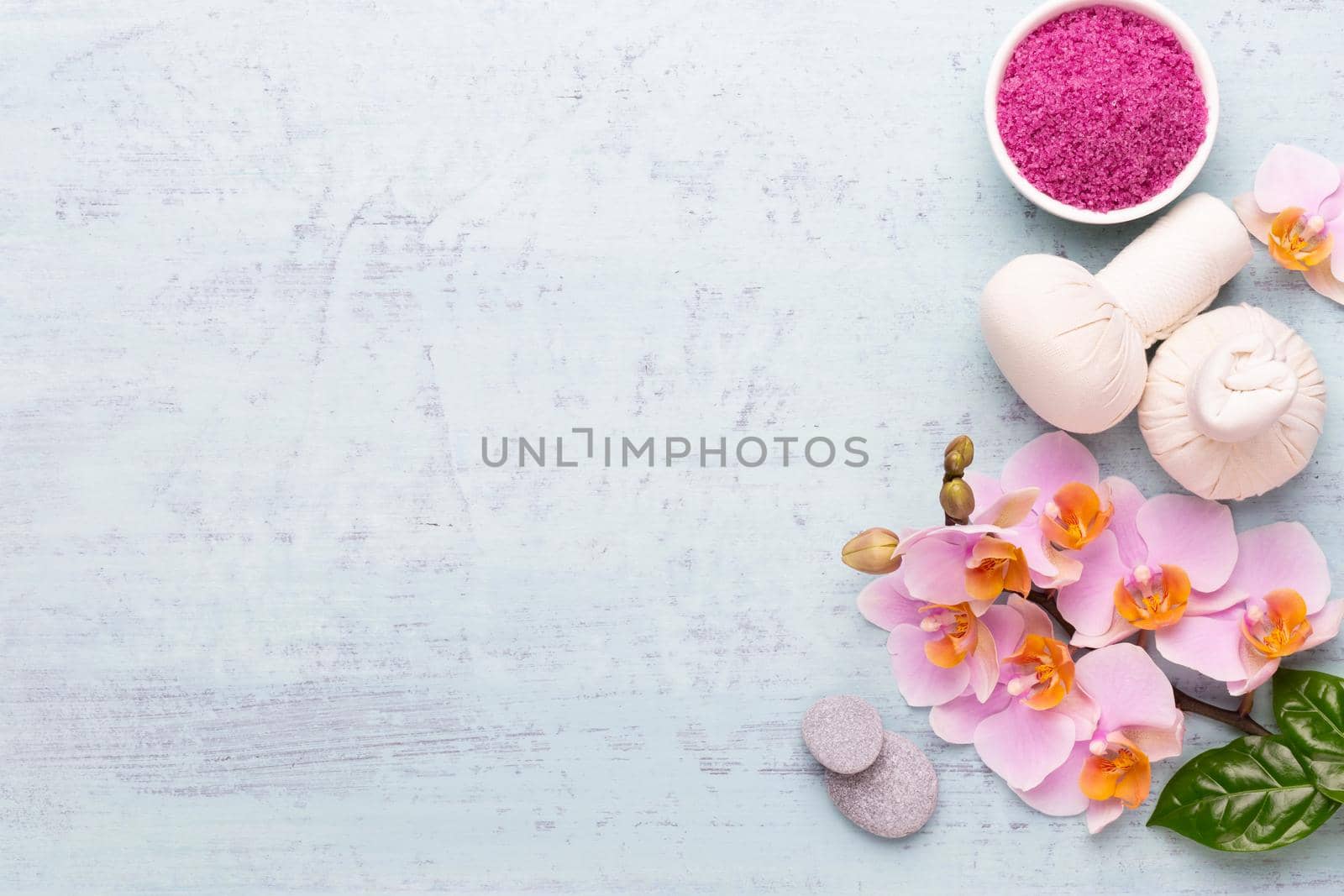 Spa aromatherapy background, flat lay of various beauty care products decorated with simple orchid flowers.