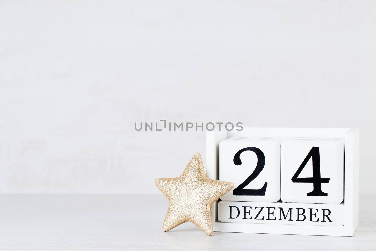 Wooden Calendar December 24 Christmas Day. On a gray background with christmas decor. by gitusik