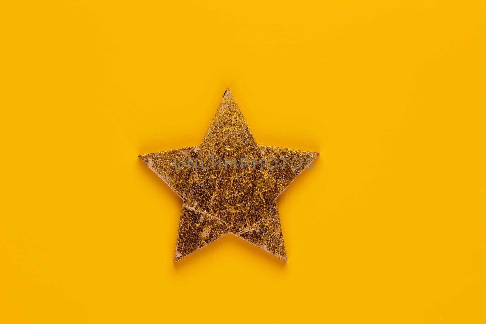 Christmas star decor on yellow colored background.  by gitusik