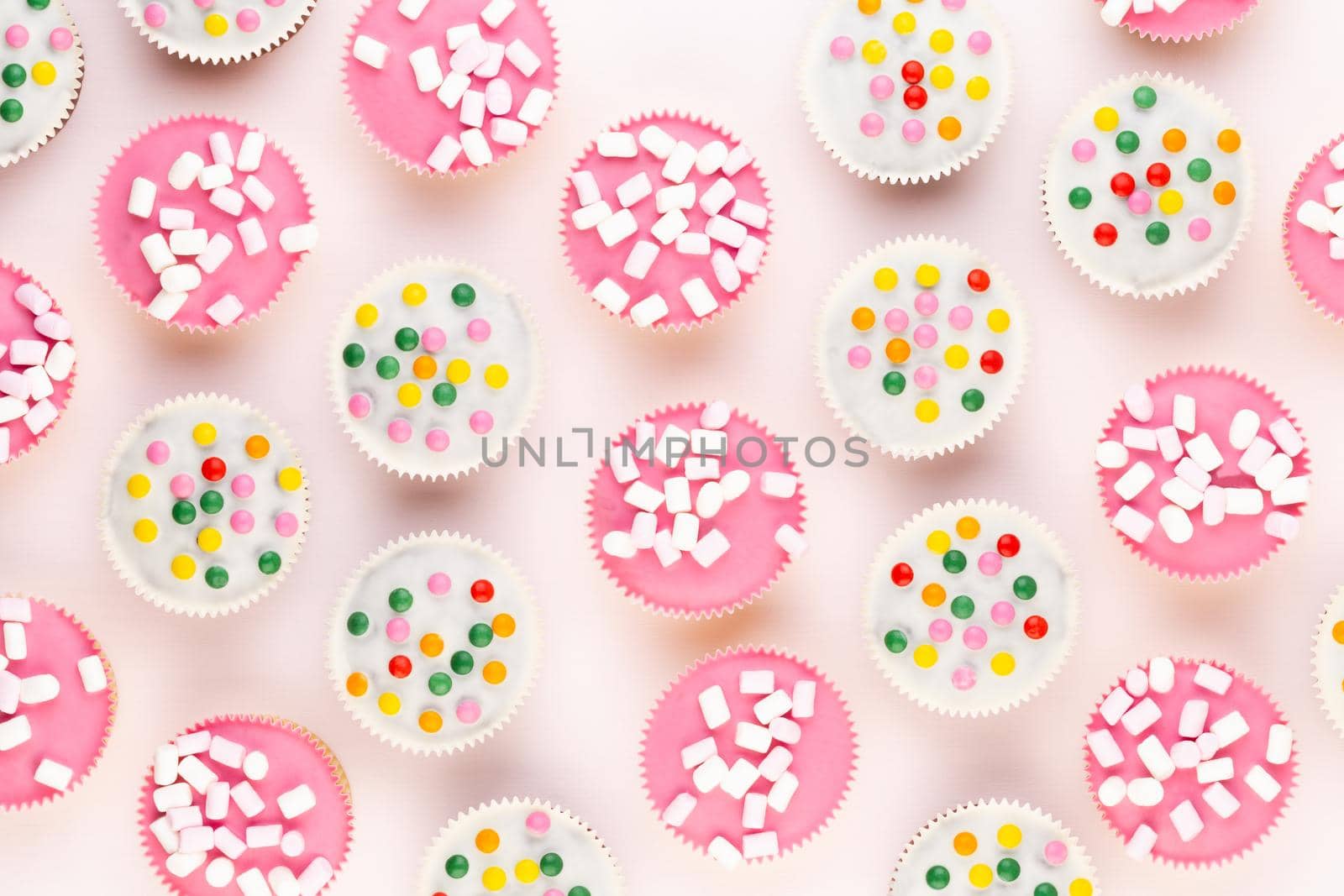 Colorful cupcakes on a white background.  by gitusik