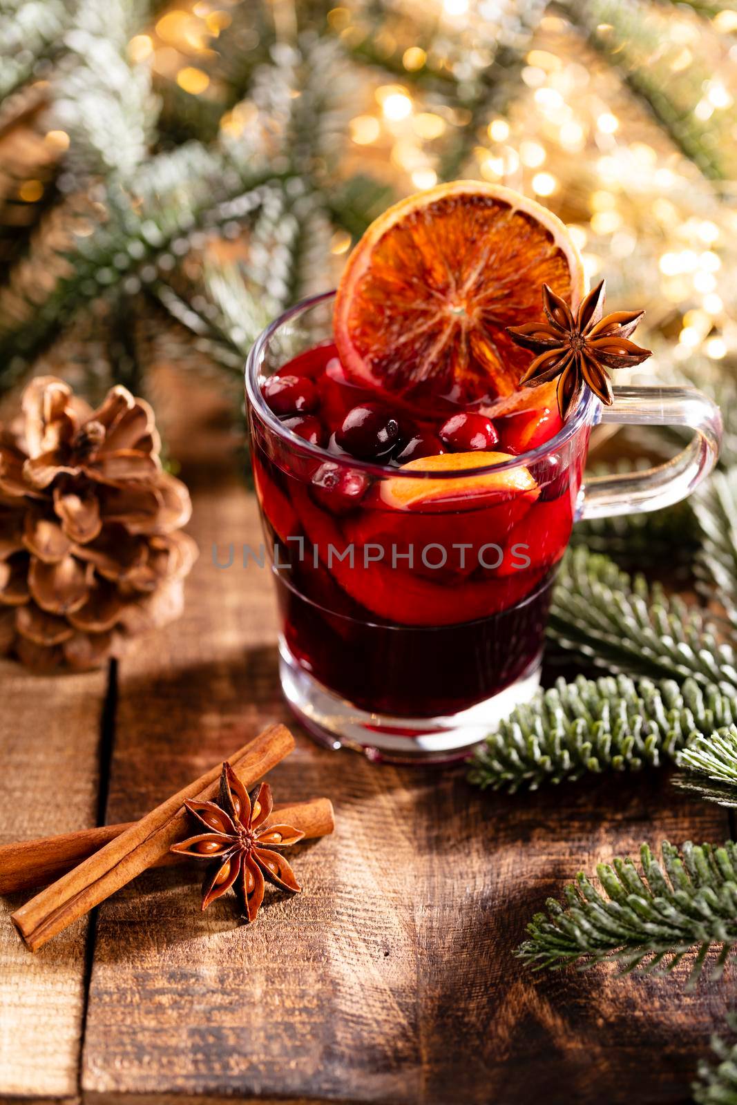 Christmas mulled wine with spices on a wooden rustic table.