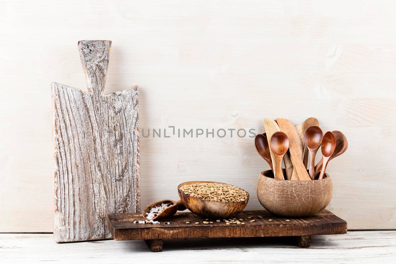 Interior design of gray kitchen wall with copper equipment and chopping board by gitusik