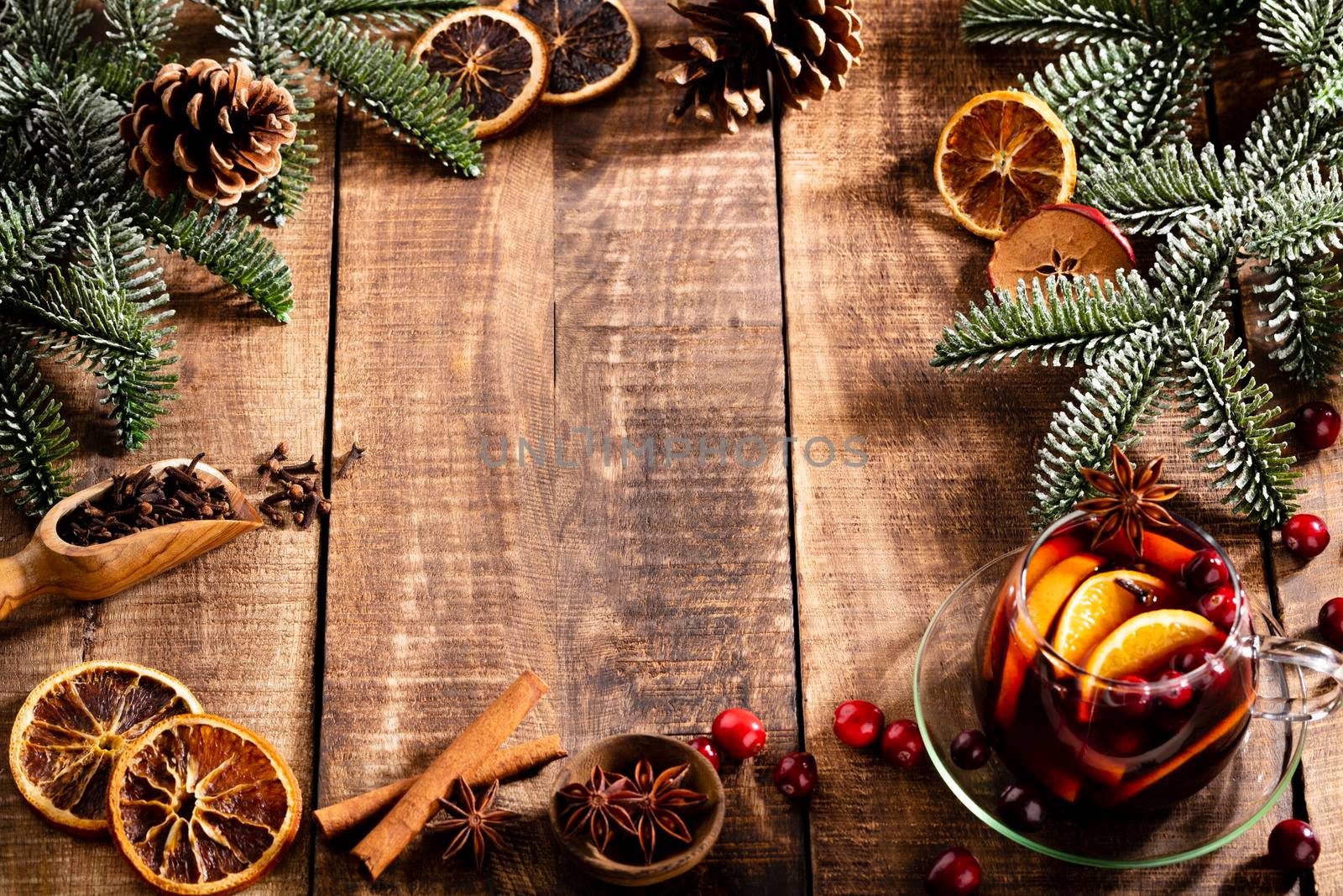Christmas mulled wine with spices on a wooden rustic table.