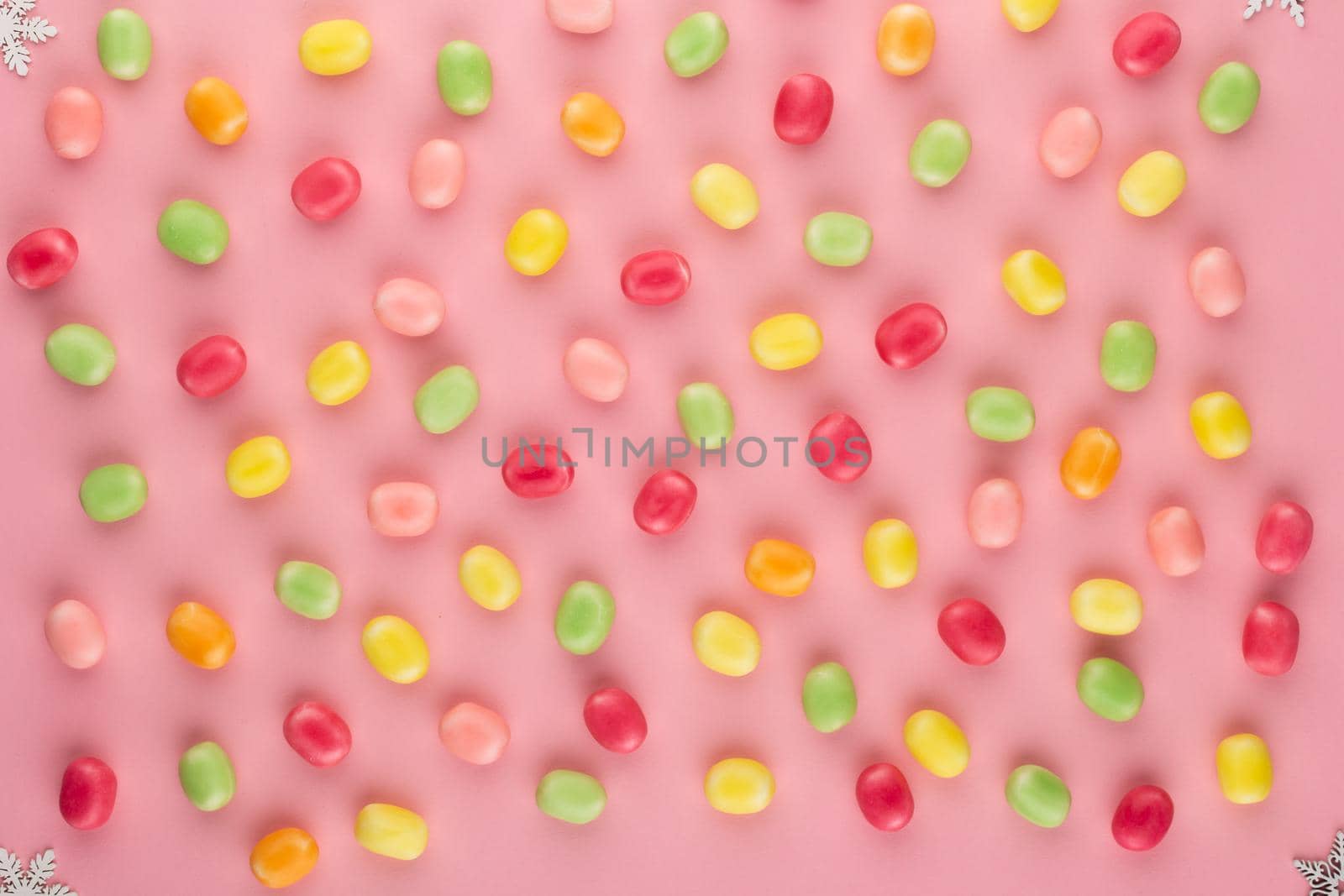 Small round candy-colored pastels on pastel background. by gitusik