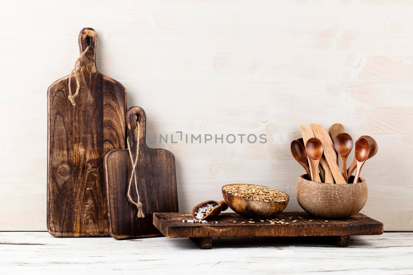 Interior design of gray kitchen wall with copper equipment and chopping board by gitusik