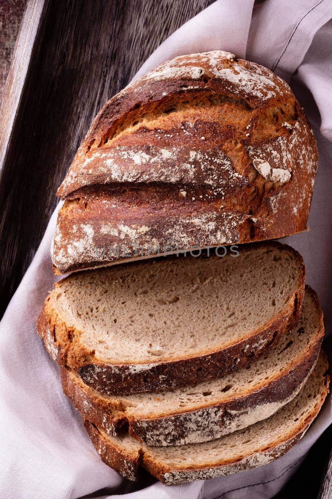 Sliced rye bread on cutting board, closeup.. by gitusik