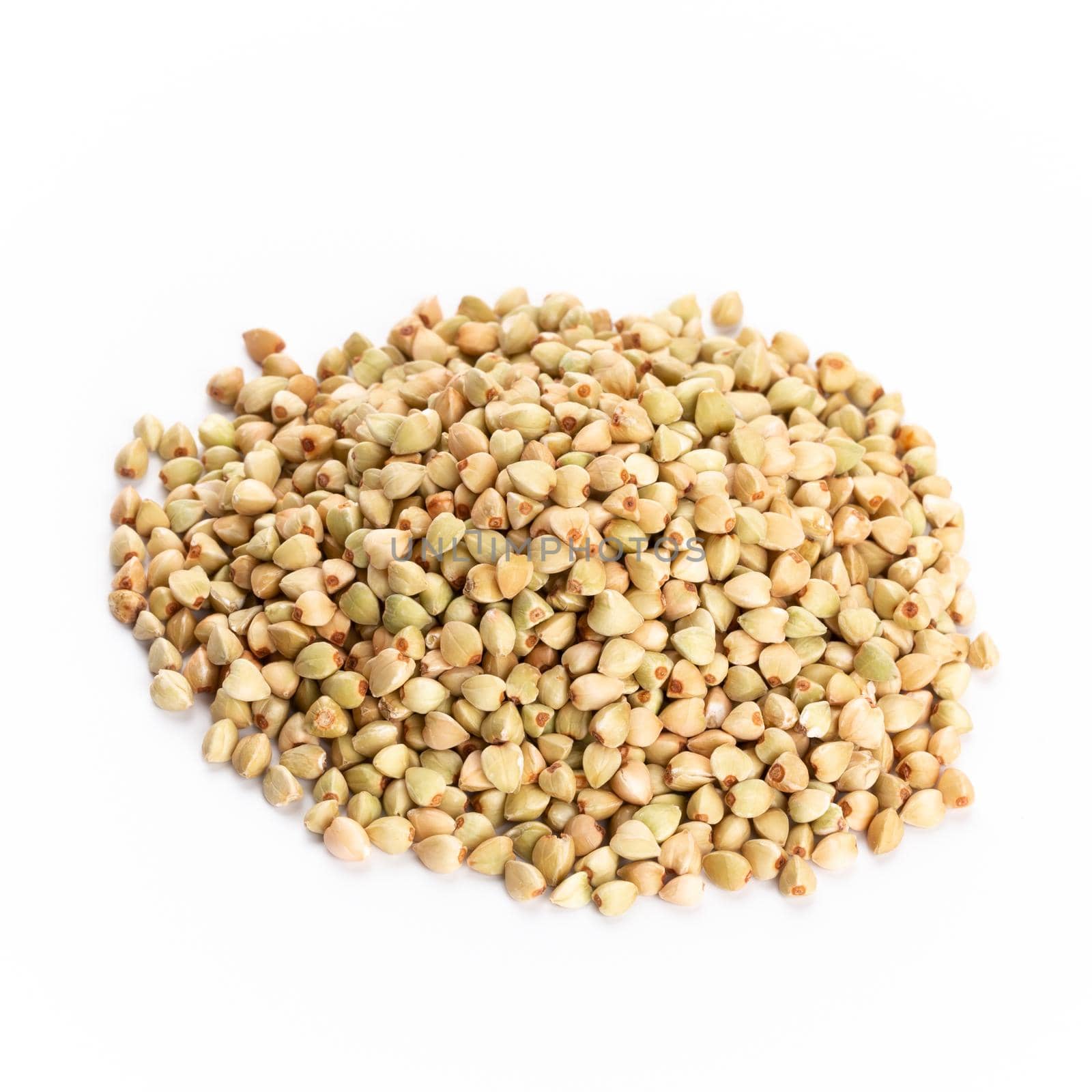 Heap of dried buckwheat seeds isolated on white background. by gitusik