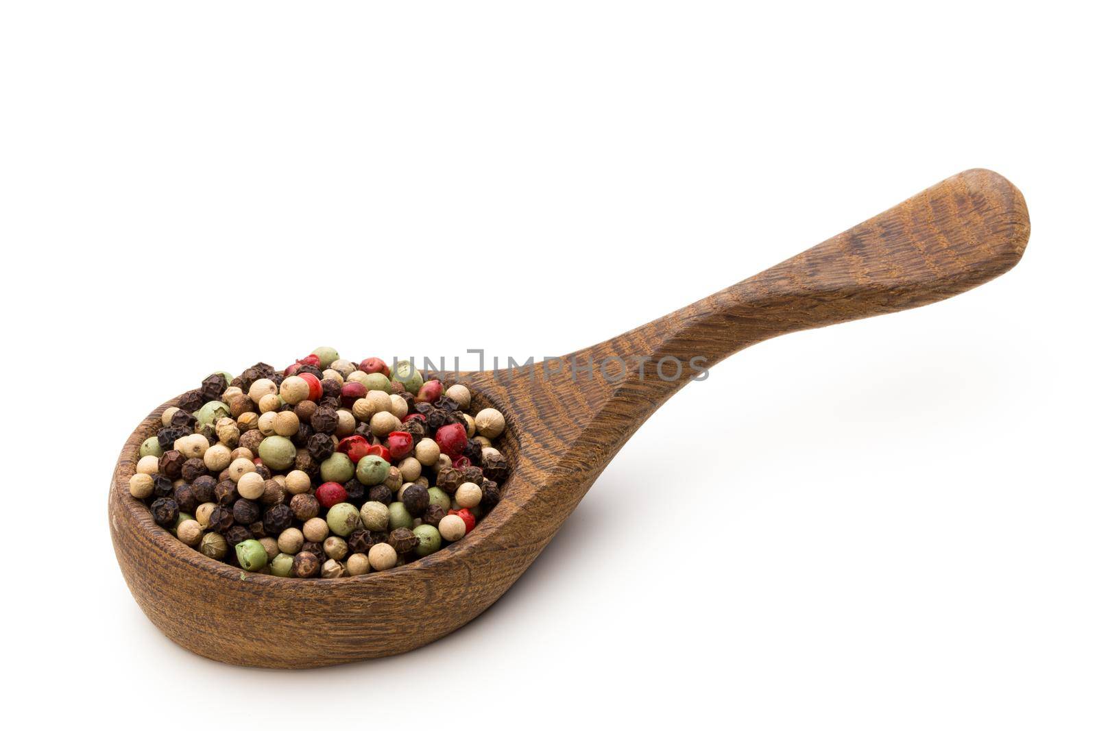 Pepper seed on spoon on white background.