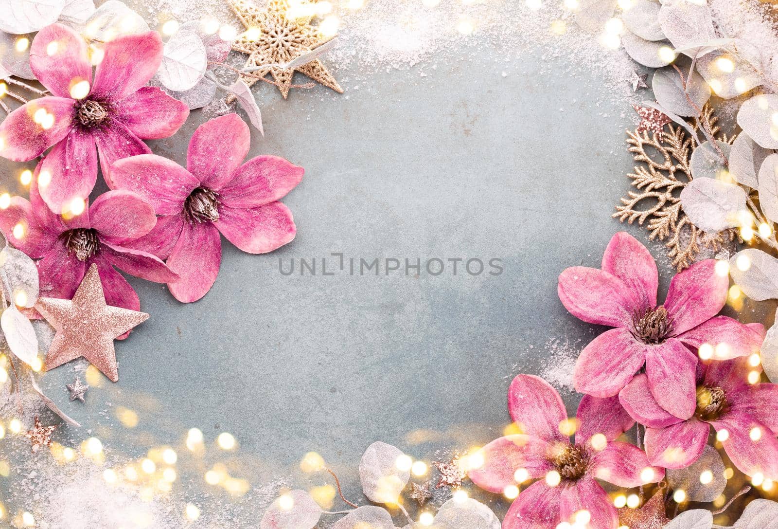 New Year celebration and Christmas background with pink flowers, snow, stars and Christmas decorations top view. by gitusik