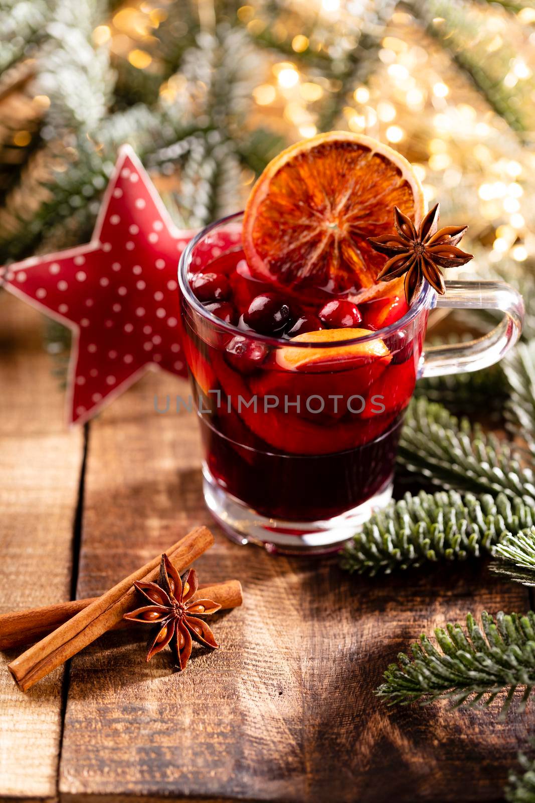 Christmas mulled wine with spices on a wooden rustic table.