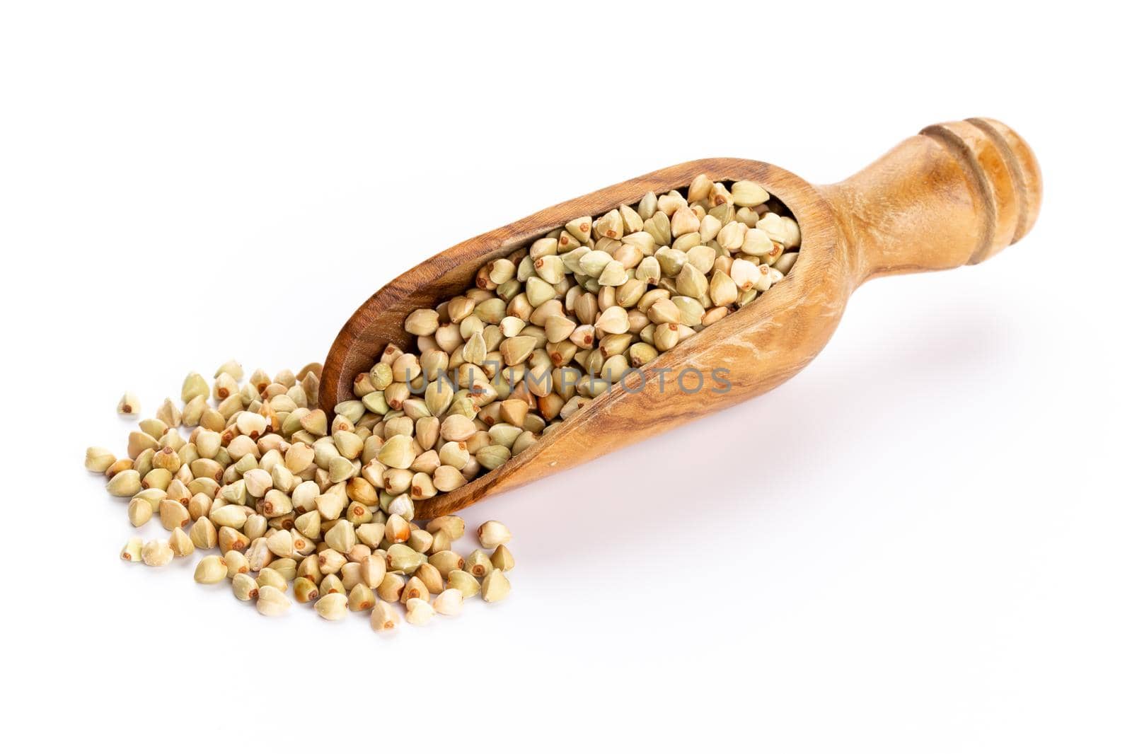 Raw buckwheat and wooden spoon on white background.