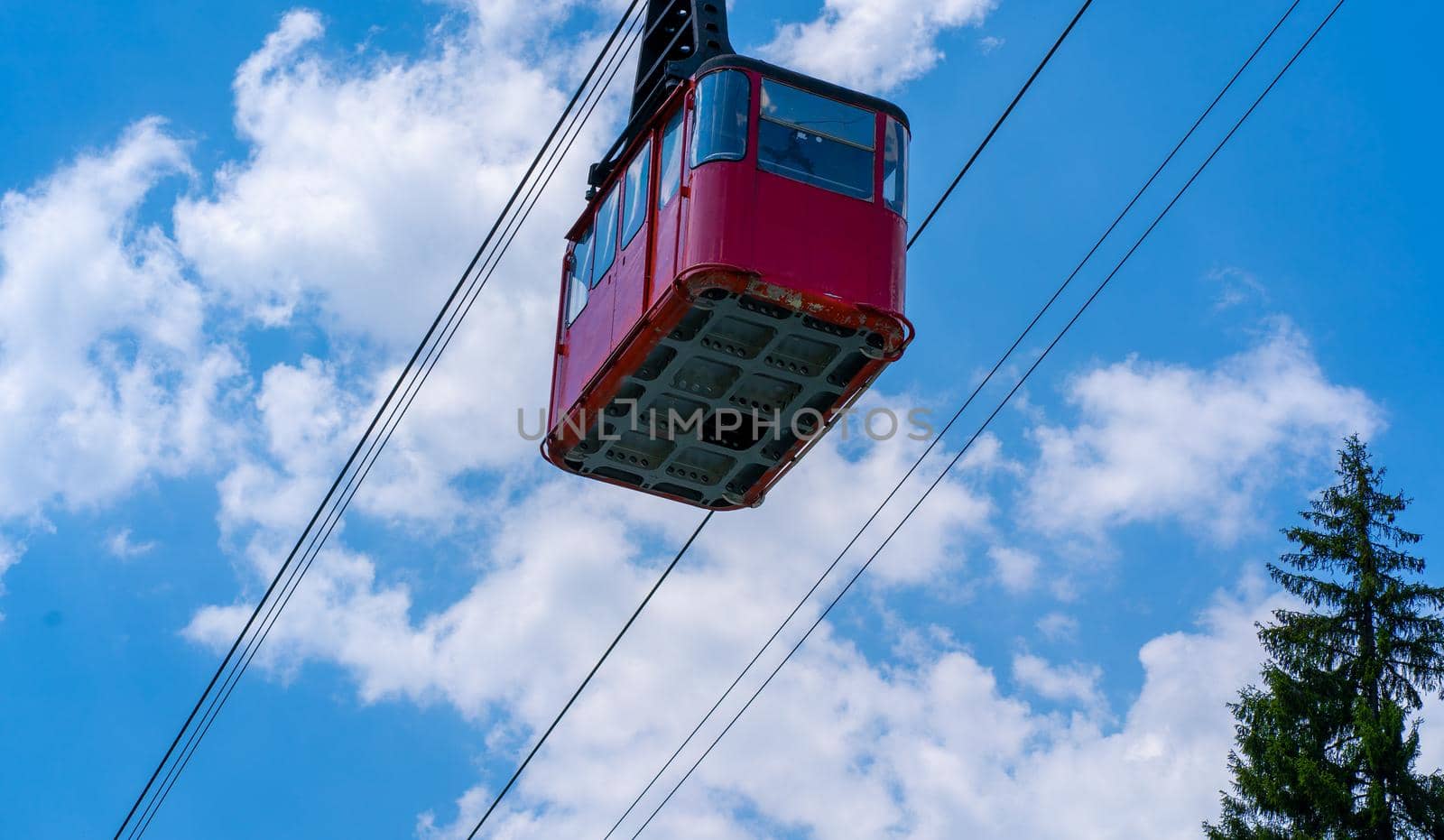 Old waggon moves along cable car in sunny weather. by epidemiks