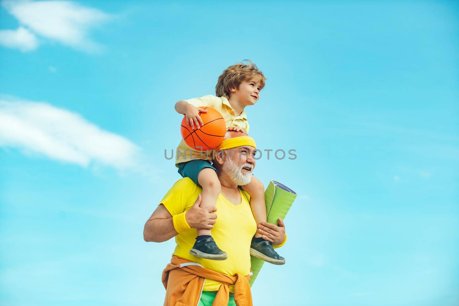 Motivation and sport concept. Sport exercise for kids. Grandfather and son doing exercises. I love sport. Outdoor activities and healthy lifestyle. by Tverdokhlib