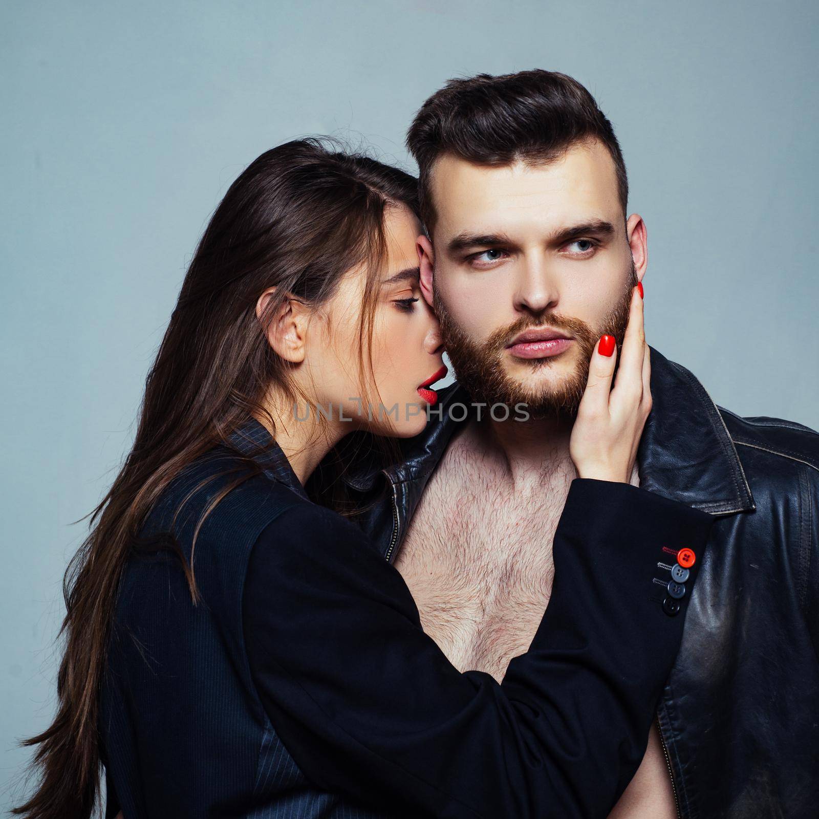 Girlfriend passionate red lips and man leather jacket. Passionate hug. Couple passionate people in love. Passion fashion. Man brutal well groomed macho and attractive feminine girl long hair cuddling.