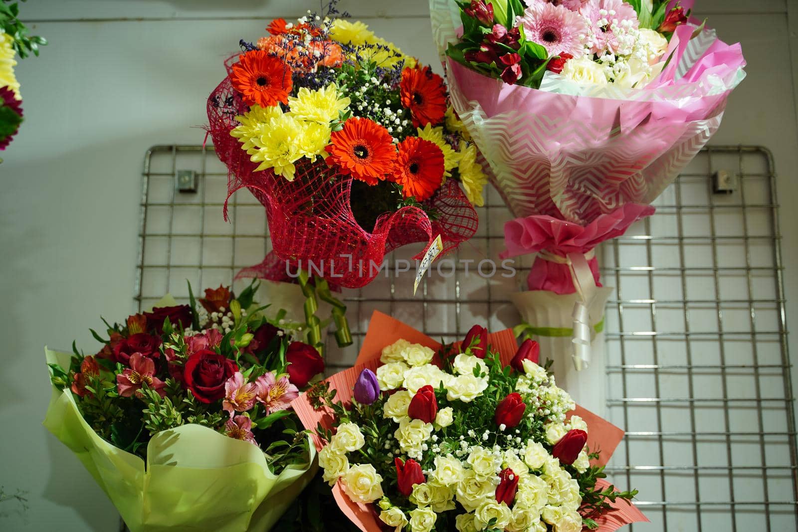 Bouquets of various flowers on counter. Fresh beautiful flowers in florist shop. by epidemiks