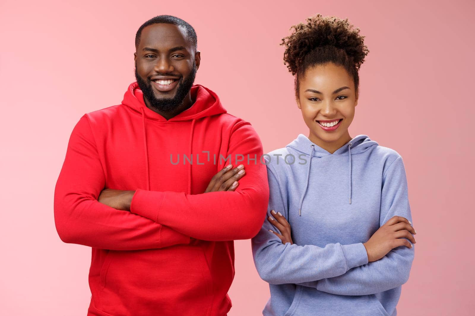 Charming happy professional team two african american man girl smiling broadly self-assured own abilities cross arms chest grinning friendly unbeatable working together, standing pink background.