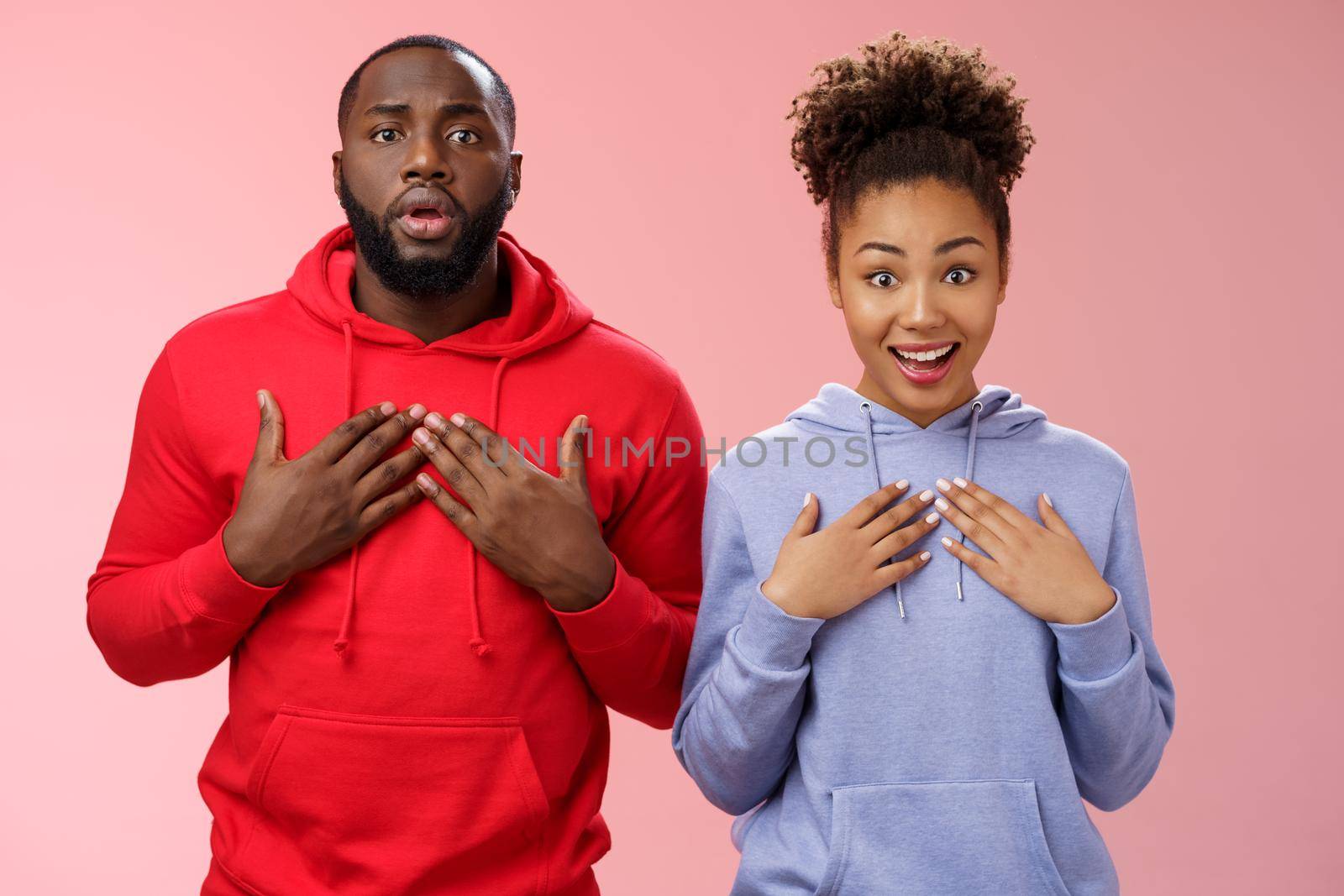Two best friends casting one role waiting result press palms chest wanna picked girl triumphing look surprised happily smiling receive offer man upset lose chance was not selected, pink background.