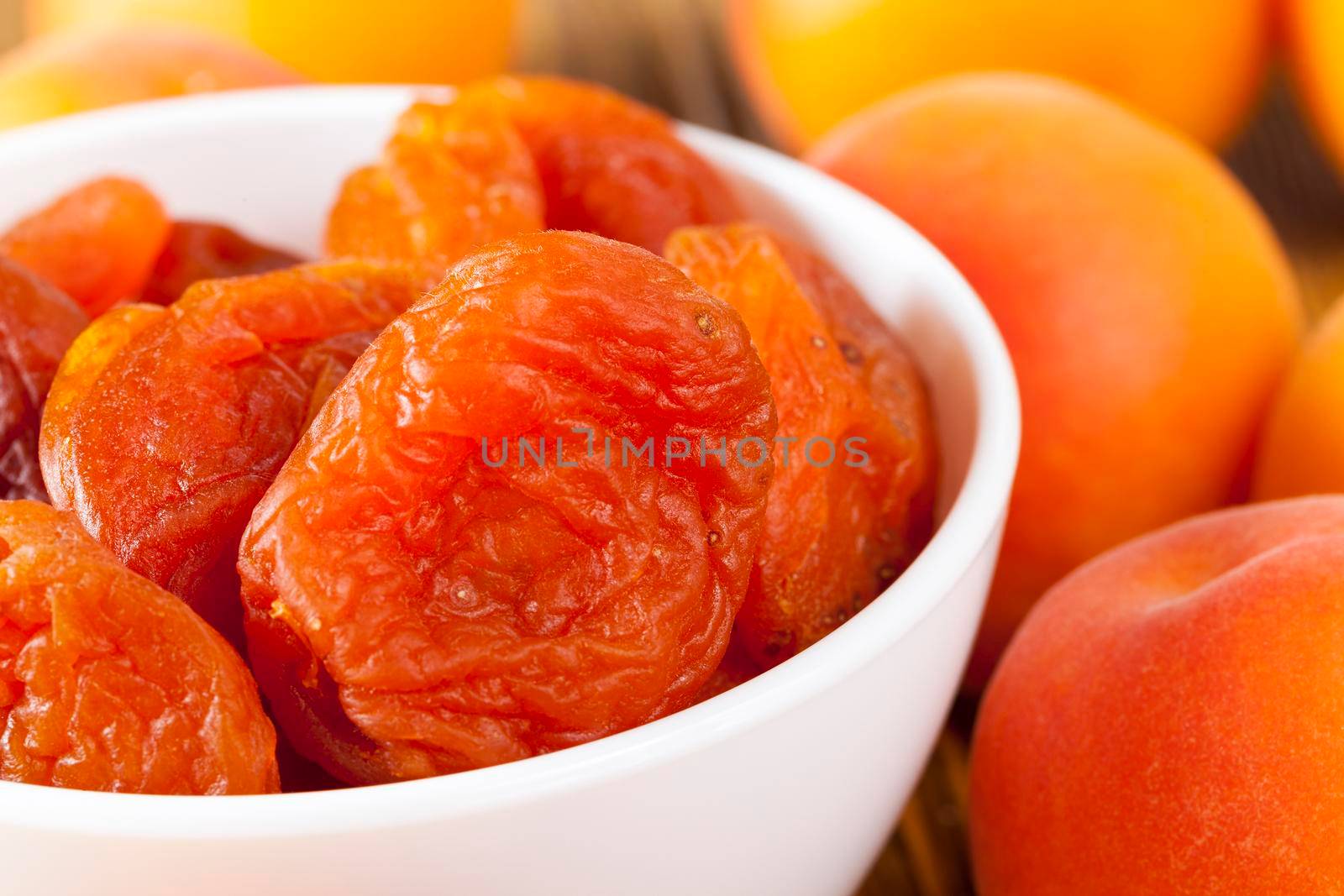 new dried apricots and fresh fruits lying together during the preparation of desserts, closeup