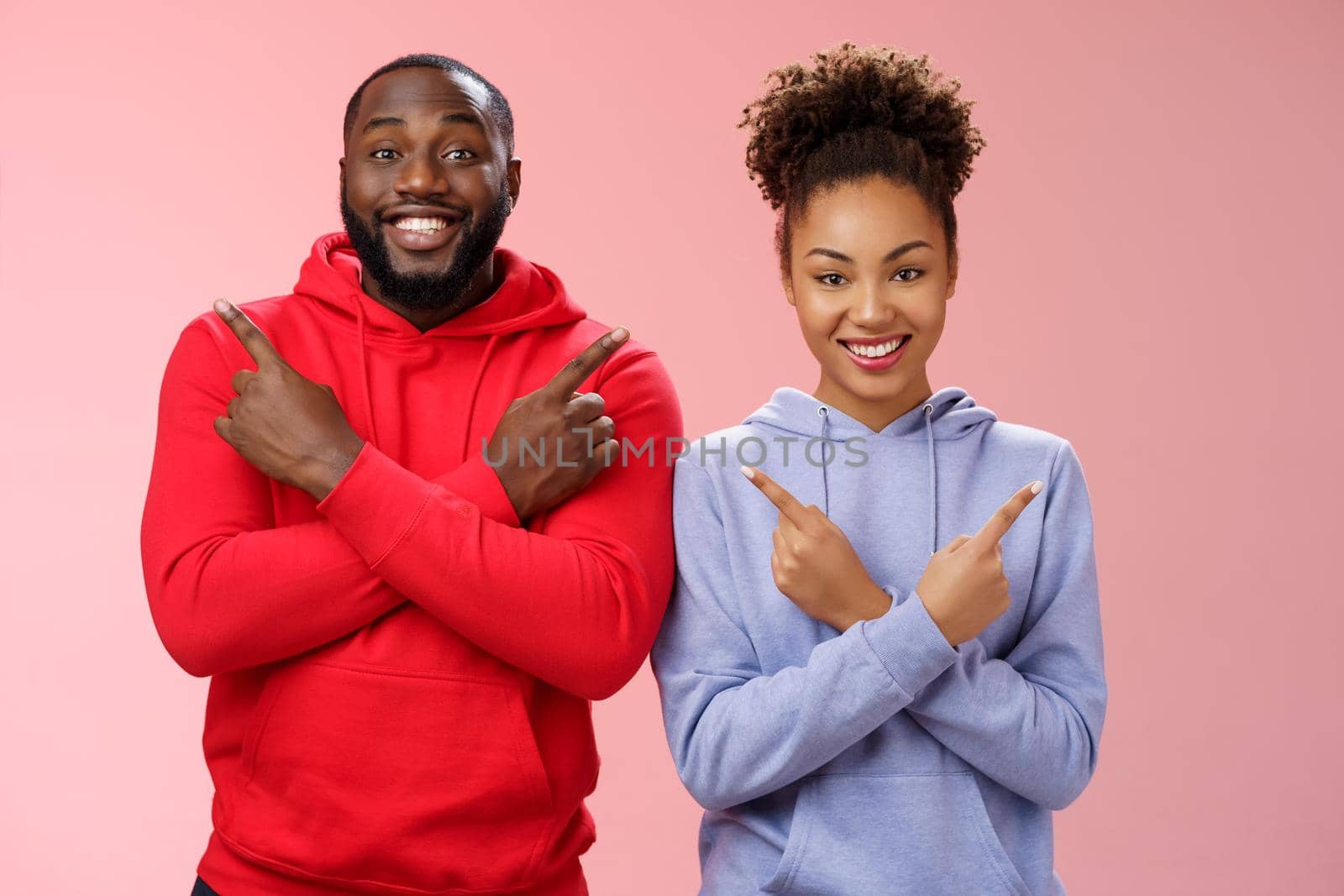 Charming happy couple african american boyfriend girlfriend move in together pointing different sides cross arms chest left right smiling broadly upbeat have variety good choices opportunities.