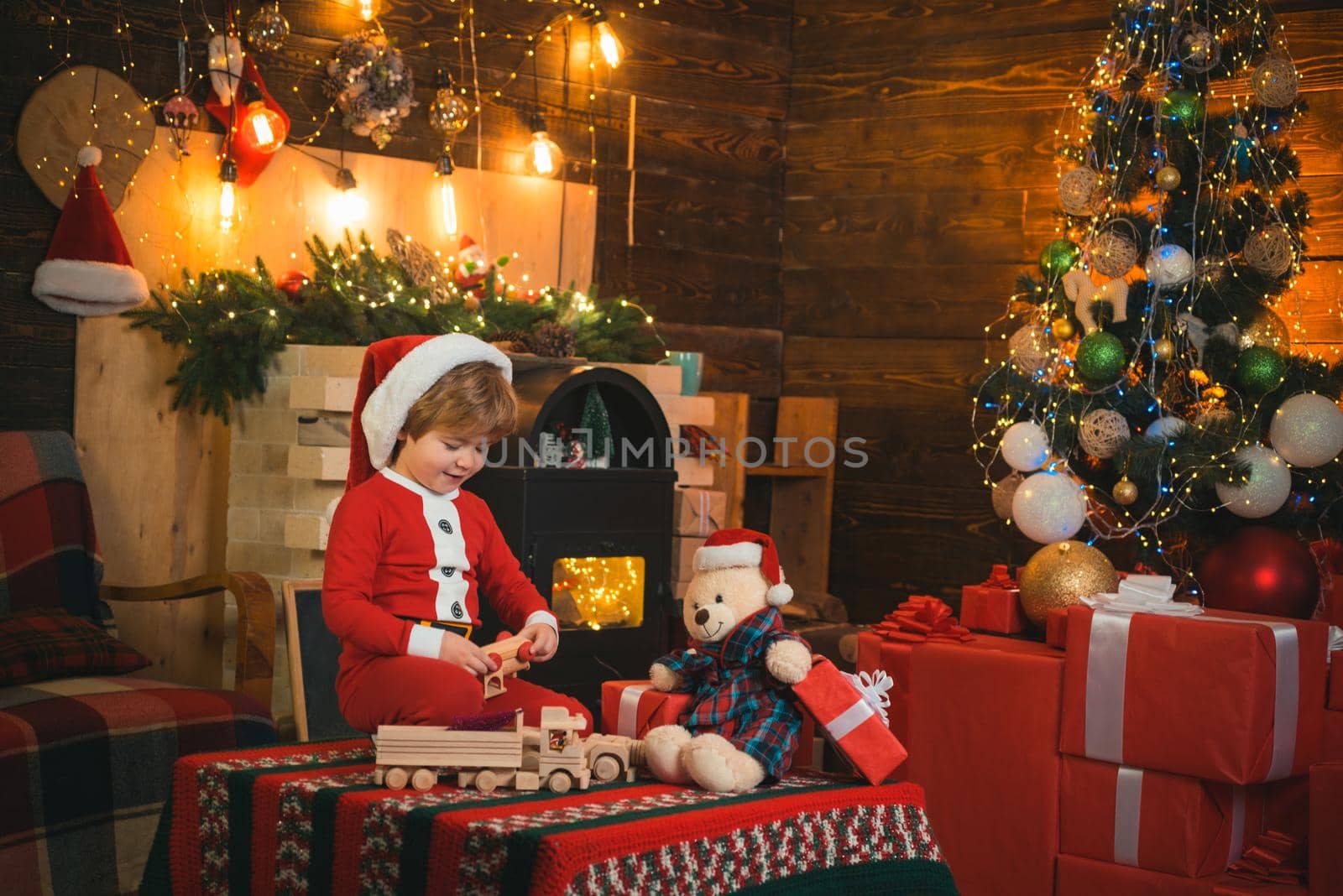 New year countdown. Merry and bright christmas. Lovely baby enjoy christmas. Family holiday. Childhood memories. Santa boy little child celebrate christmas at home. Boy child play near christmas tree.