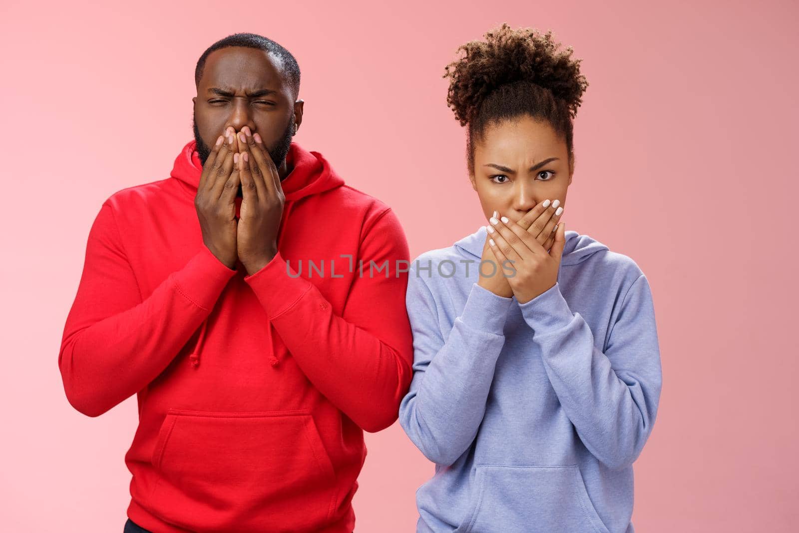 Romantic couple african american boyfriend girlfriend feel sick after eating dinner restaurant press palms mouth frowning wanna puke vomit, standing disgusted shocked pink background by Benzoix