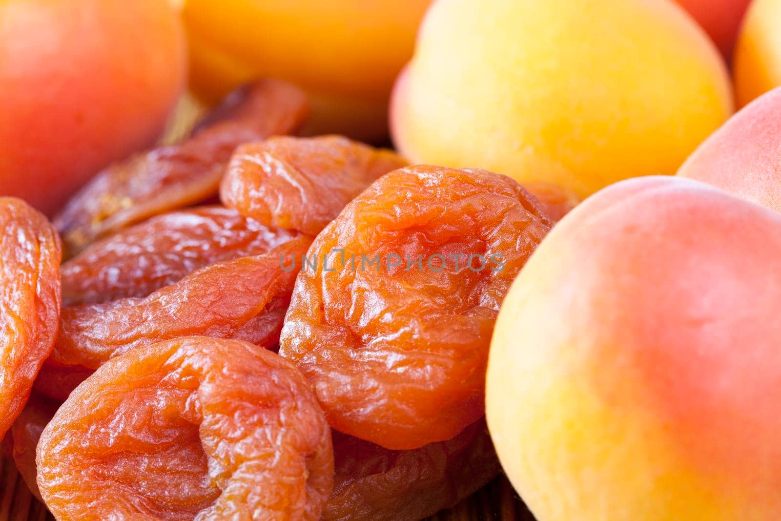 a bunch of very dry and fresh natural apricots lying in a pile, a photo of a closeup of dried fruits