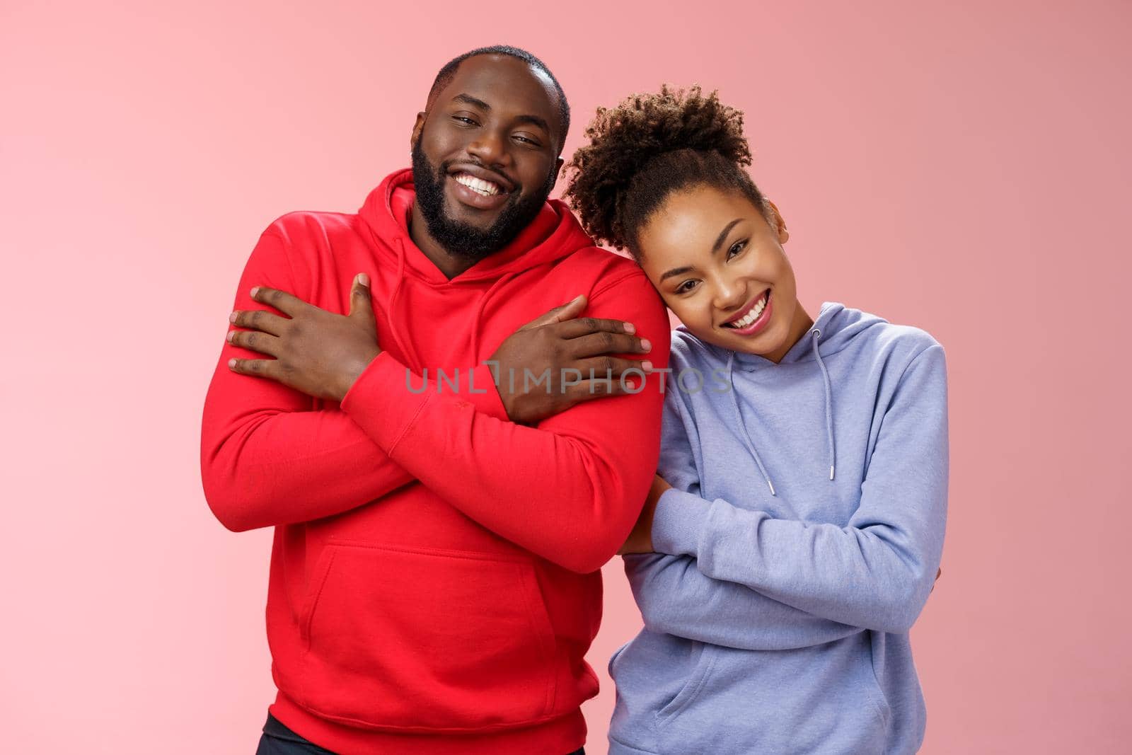 Charming happy sincere african-american family guy girl relationship embracing cross arms chest hugging each other girlfriend lean boyfriend shoulder lovely couply smiling feel love warmth.