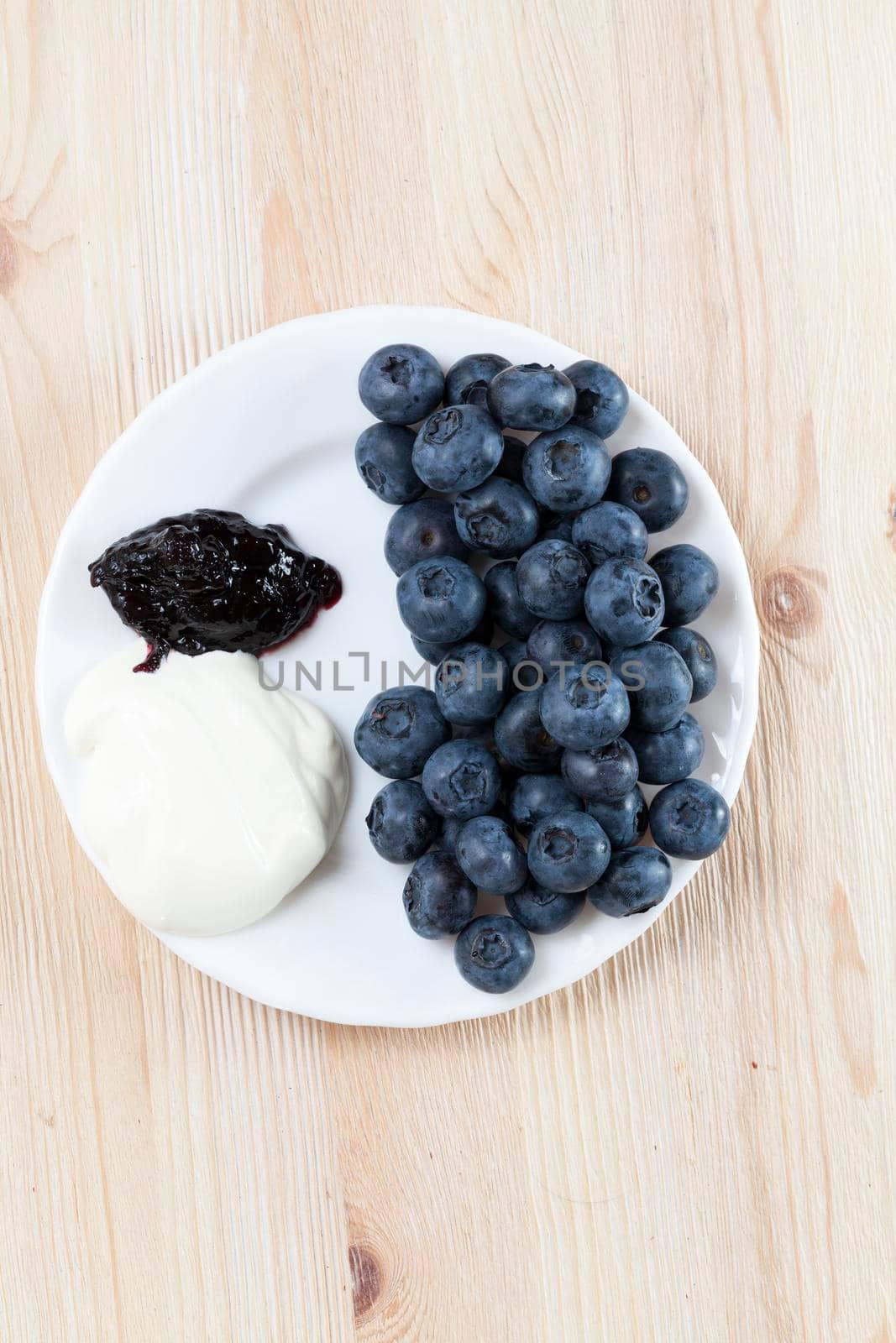 made at home dessert of blueberries, milk sauce on a wooden background